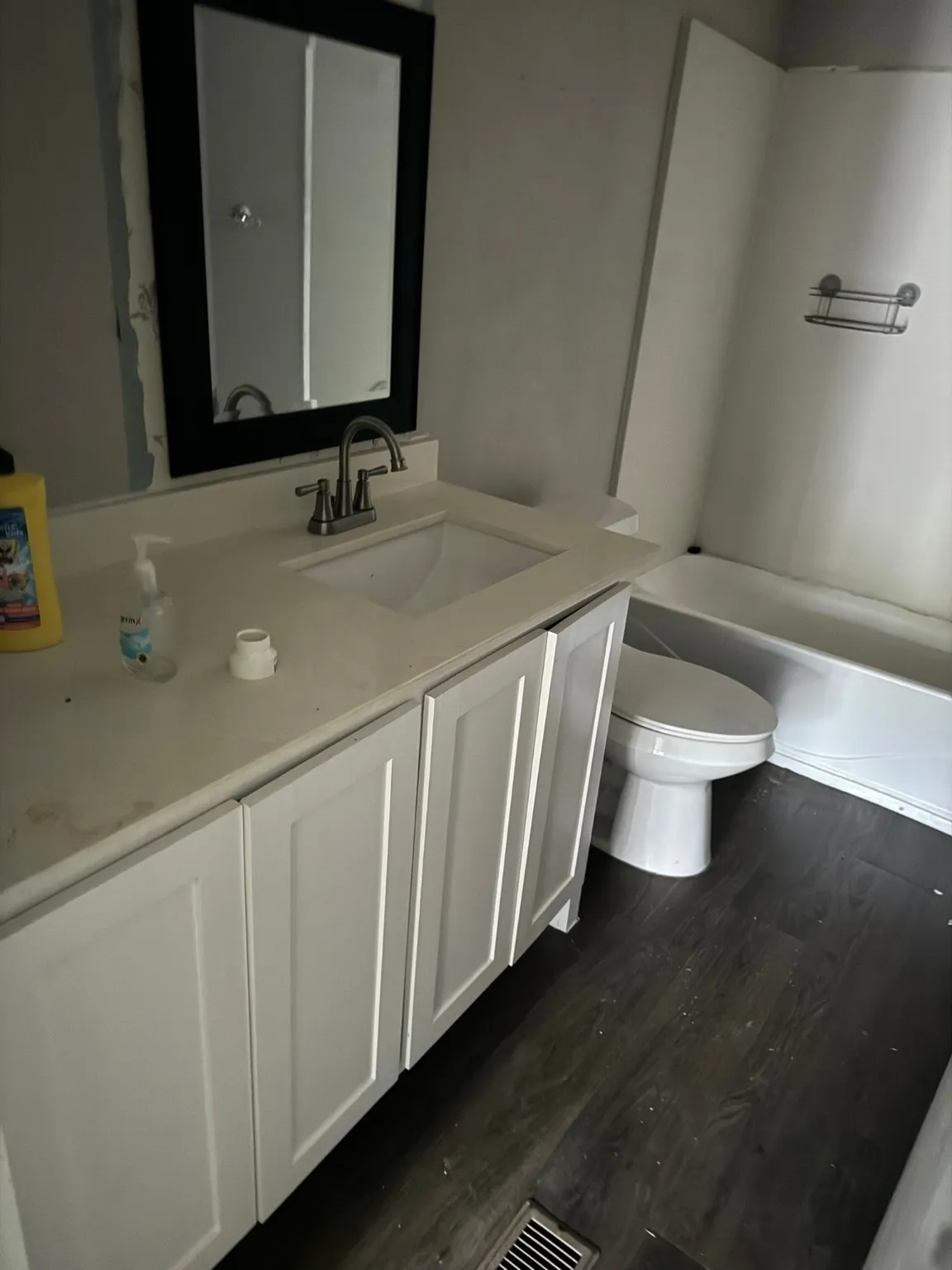 Full bathroom with hardwood / wood-style floors, vanity, toilet, and shower / bathtub combination