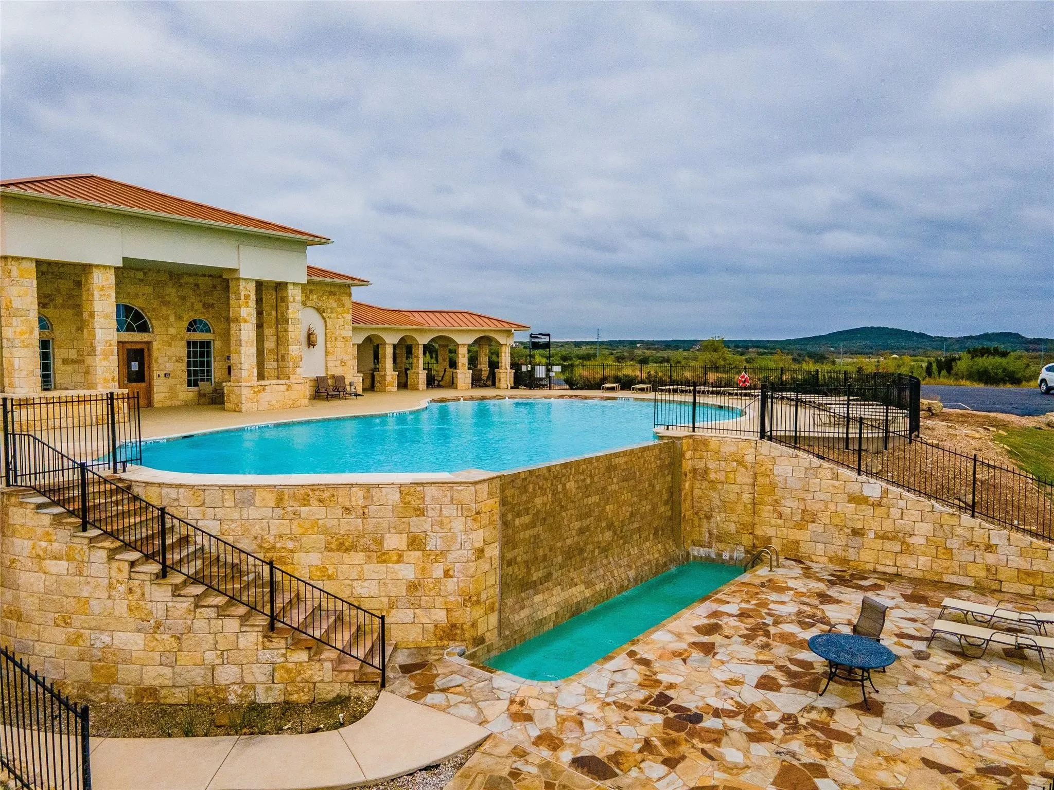 View of pool with a mountain view and a patio