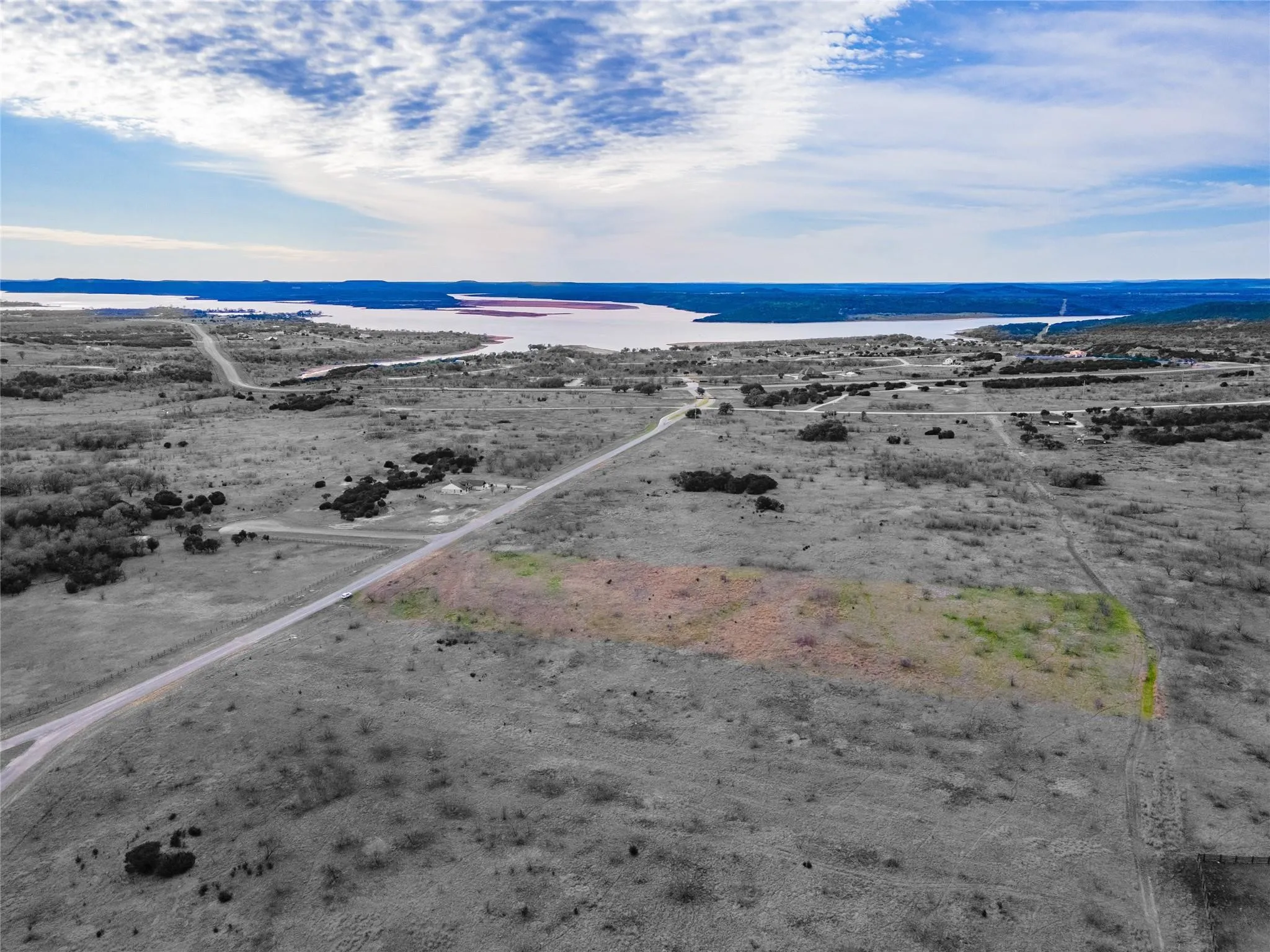 Aerial view featuring a water view and a beach view