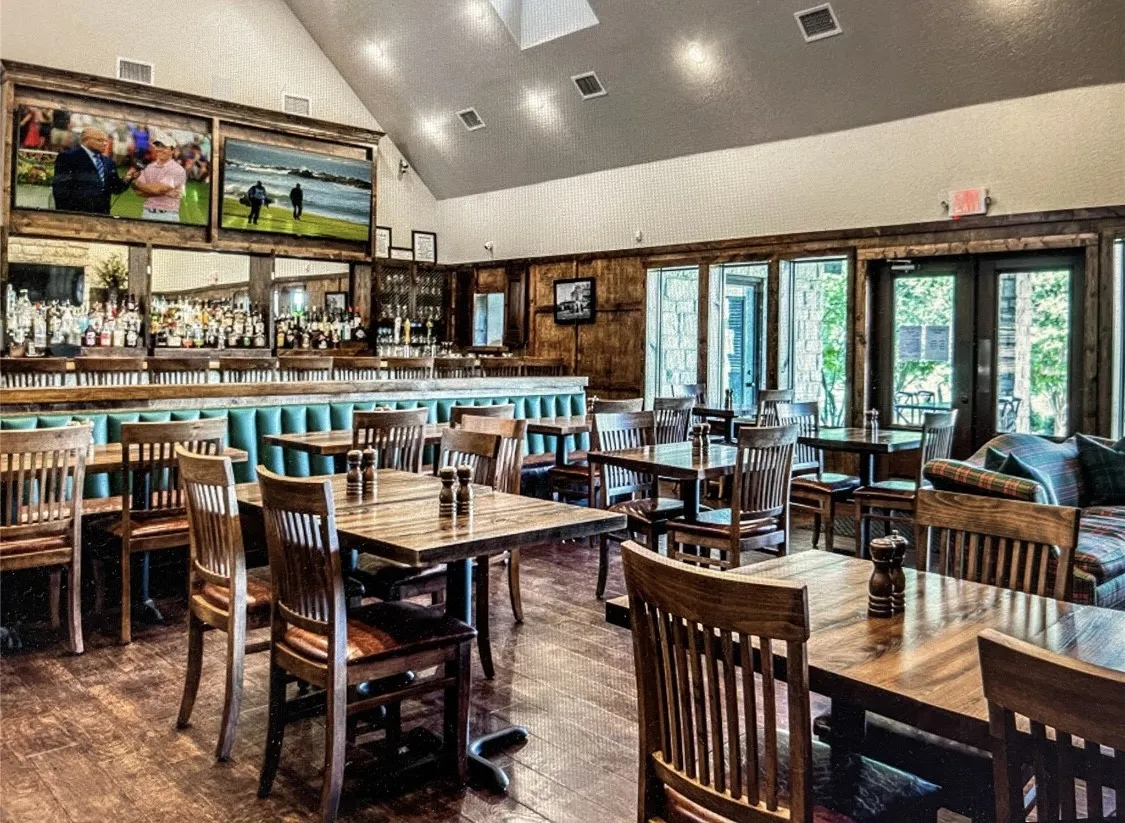 Dining space with french doors, high vaulted ceiling, and hardwood / wood-style flooring