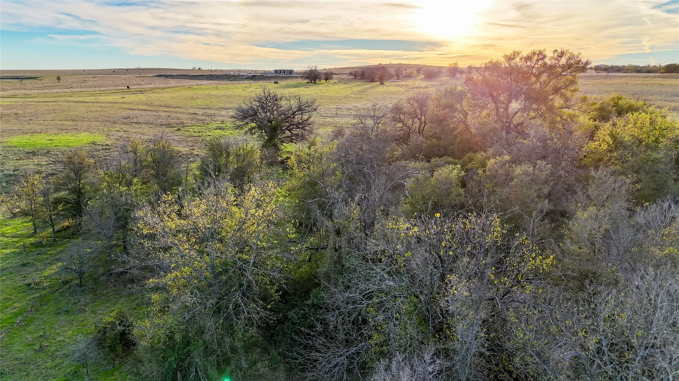 Aerial view at dusk featuring a rural view