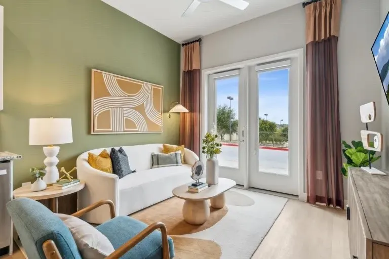 Living area with ceiling fan and light hardwood / wood-style floors