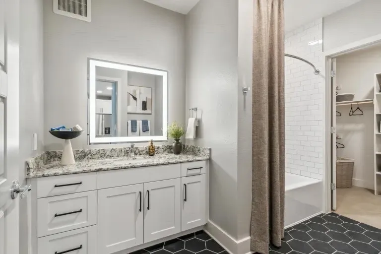 Bathroom with tile patterned flooring, vanity, and shower / bathtub combination with curtain