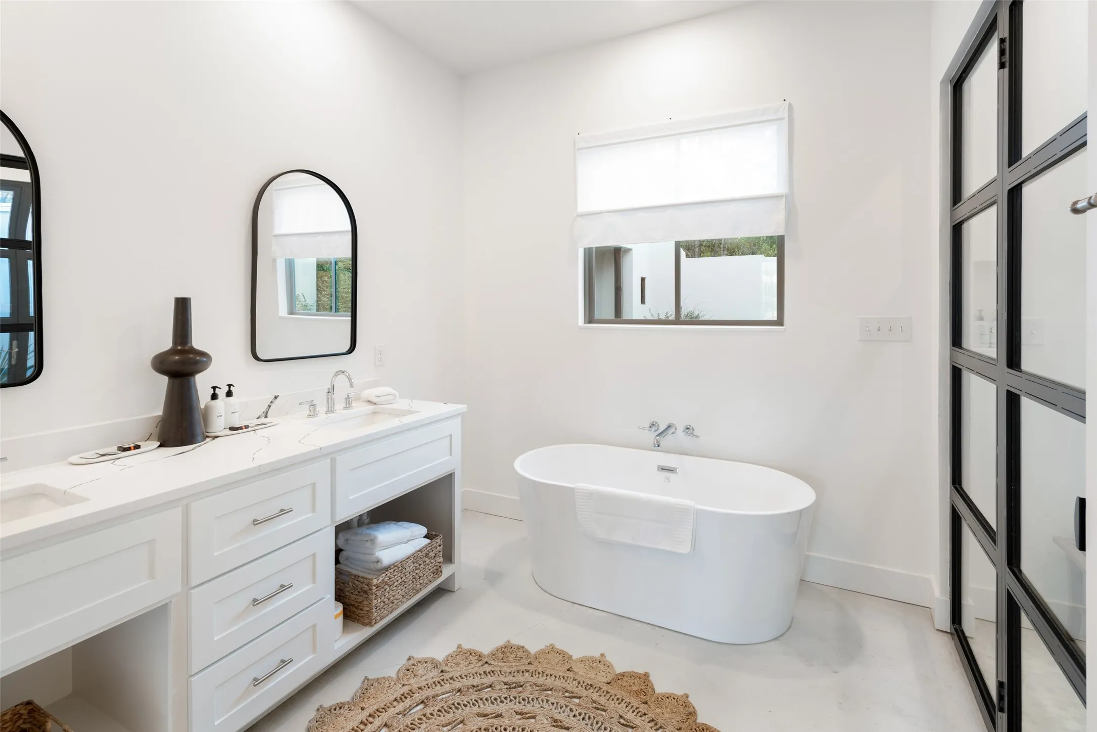 Bathroom featuring vanity, plenty of natural light, and a bathing tub