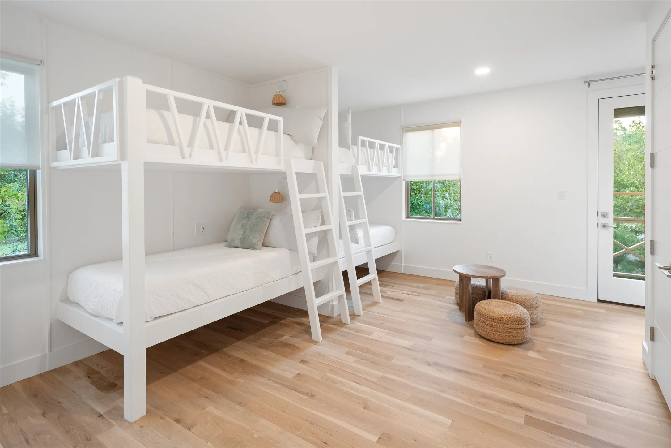Bedroom with multiple windows and hardwood / wood-style flooring