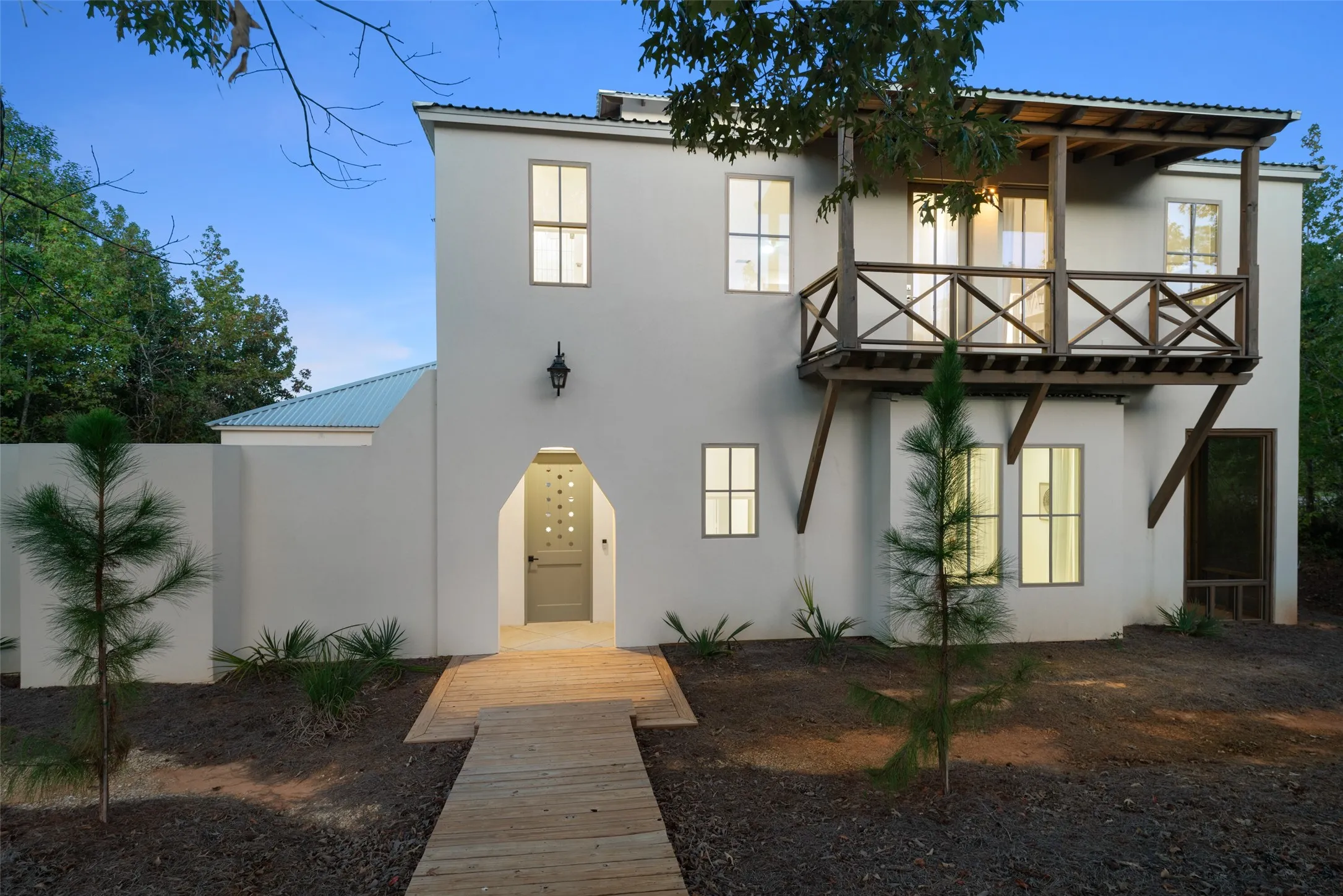 View of front of property with a balcony