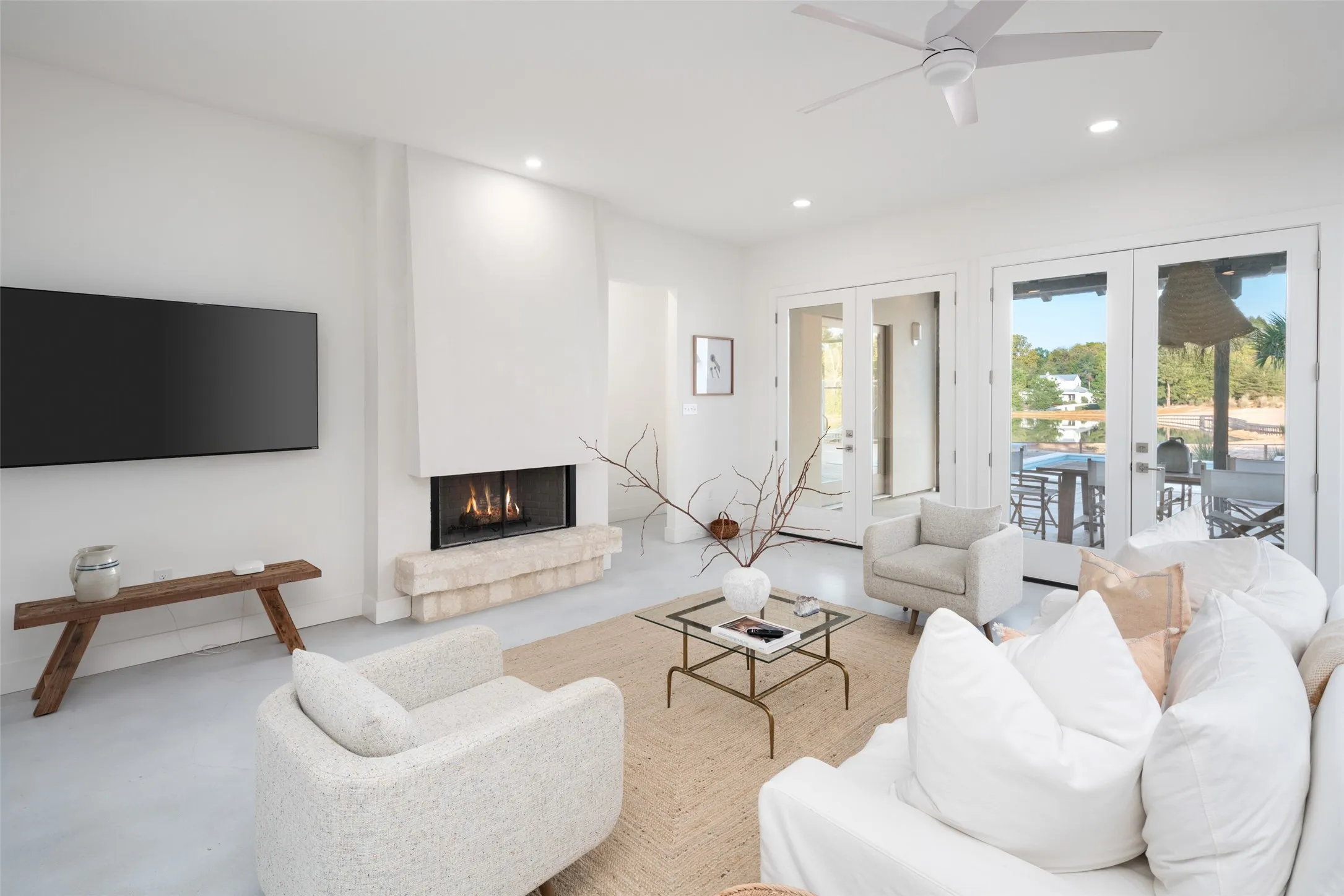 Living room featuring french doors, ceiling fan, and a fireplace