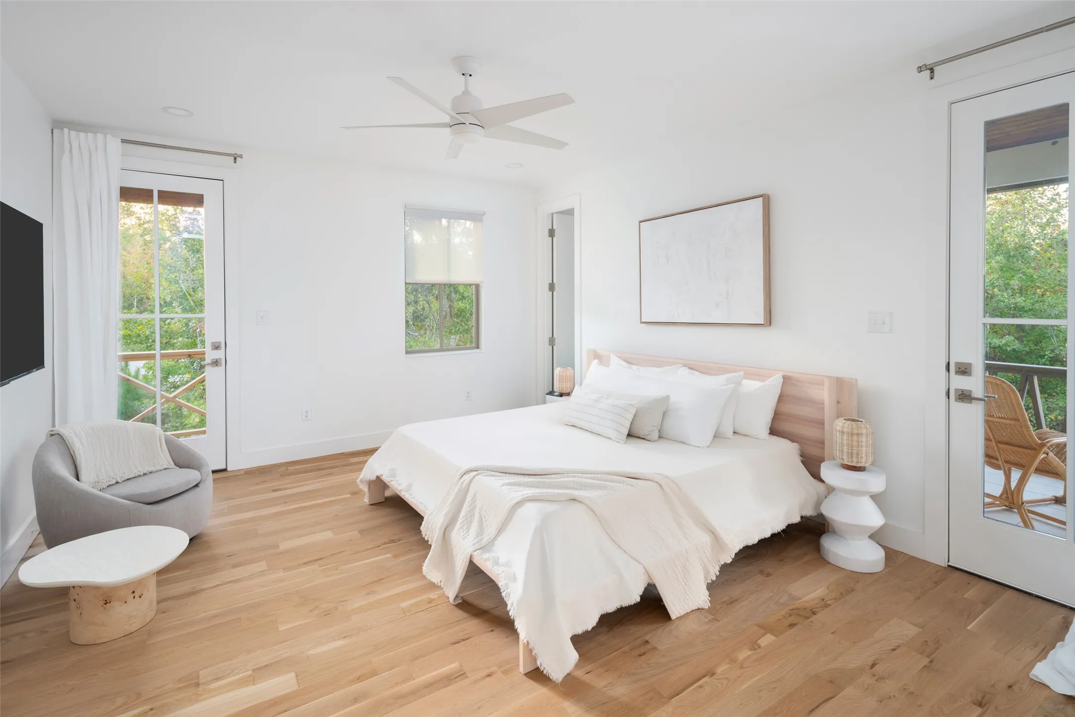 Bedroom featuring ceiling fan, light hardwood / wood-style floors, and access to exterior