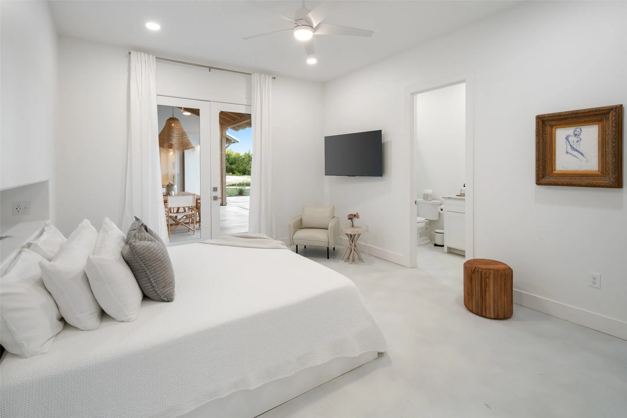 Bedroom featuring access to exterior, connected bathroom, and ceiling fan