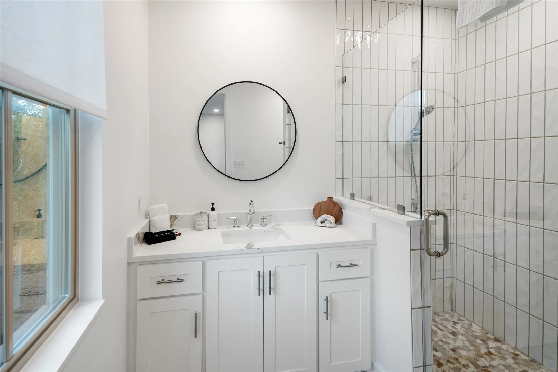 Bathroom featuring vanity and an enclosed shower