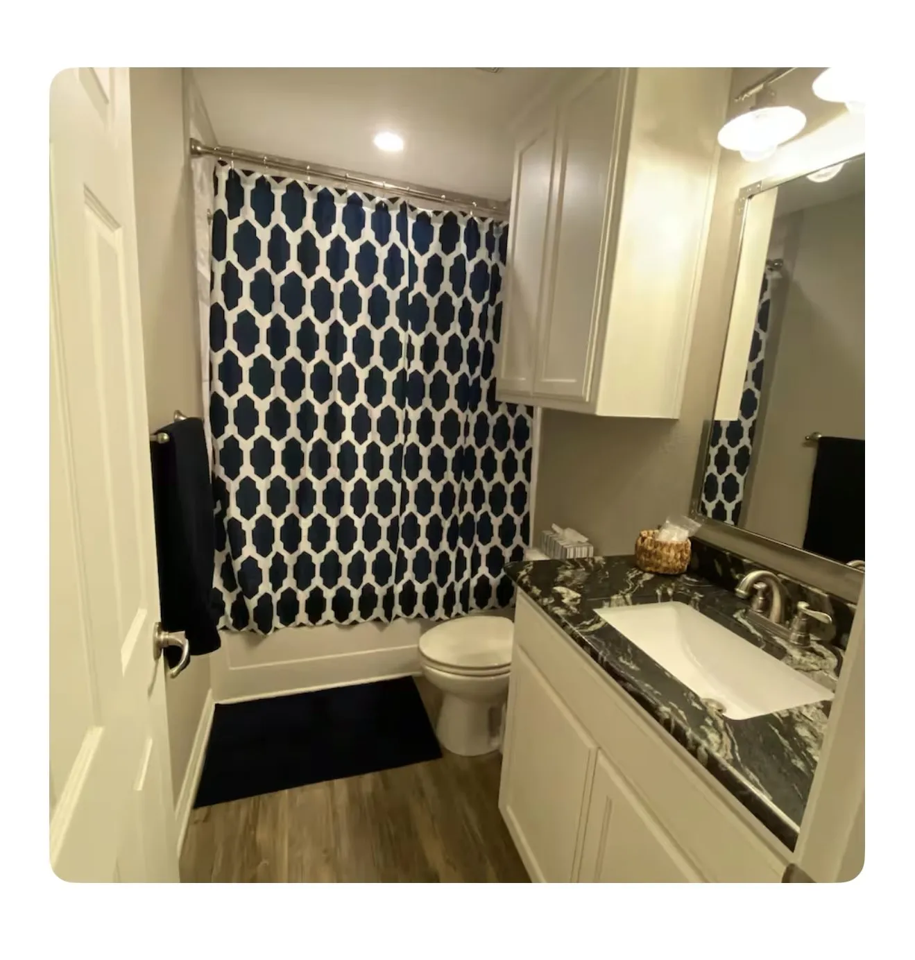 Bathroom with hardwood / wood-style floors, vanity, and toilet