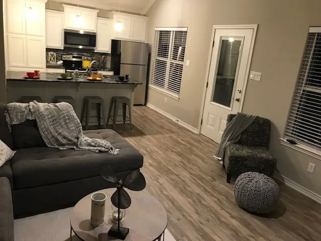 Living room featuring hardwood / wood-style flooring and ornamental molding