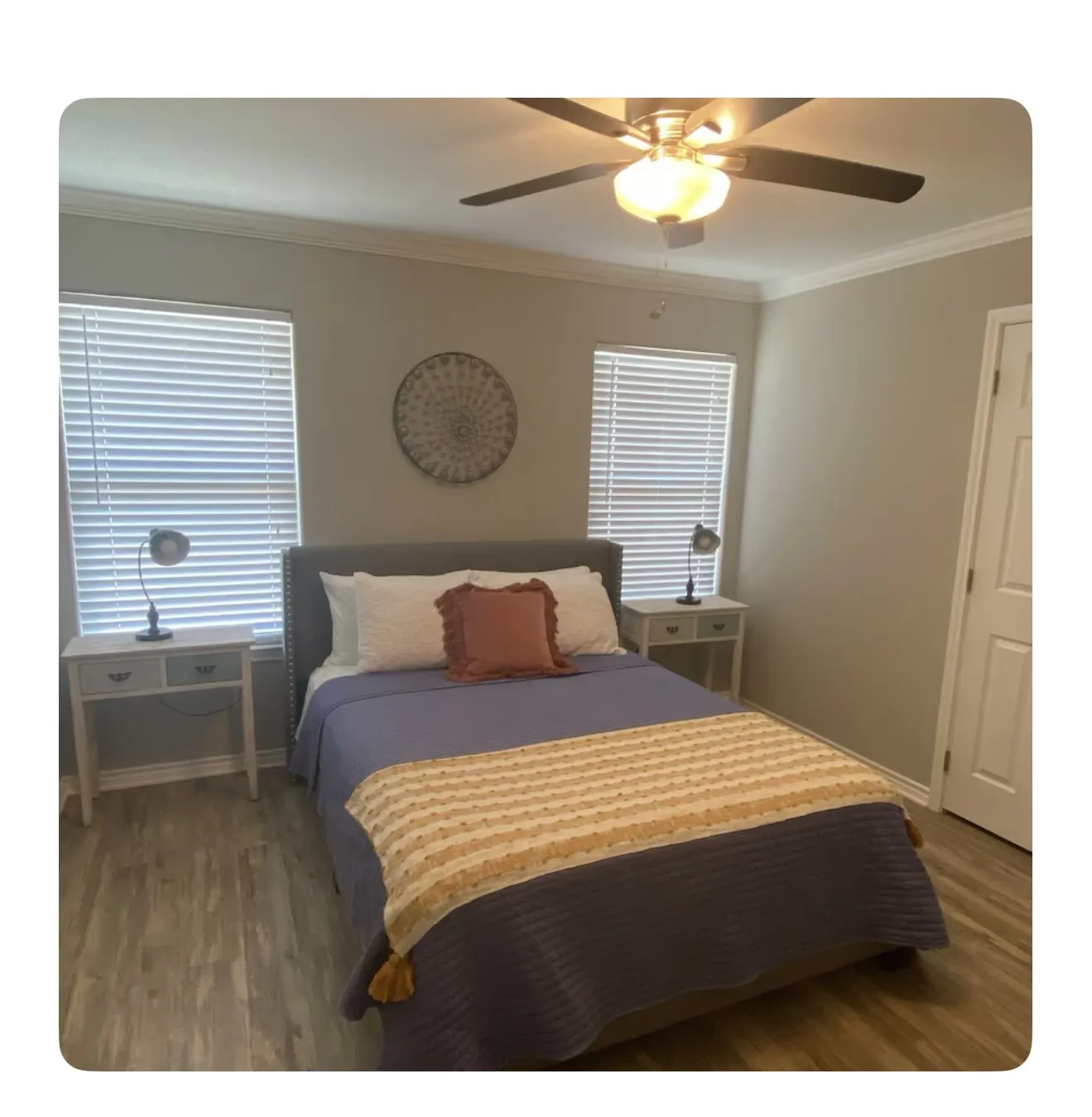 Bedroom featuring hardwood / wood-style floors, ceiling fan, and ornamental molding