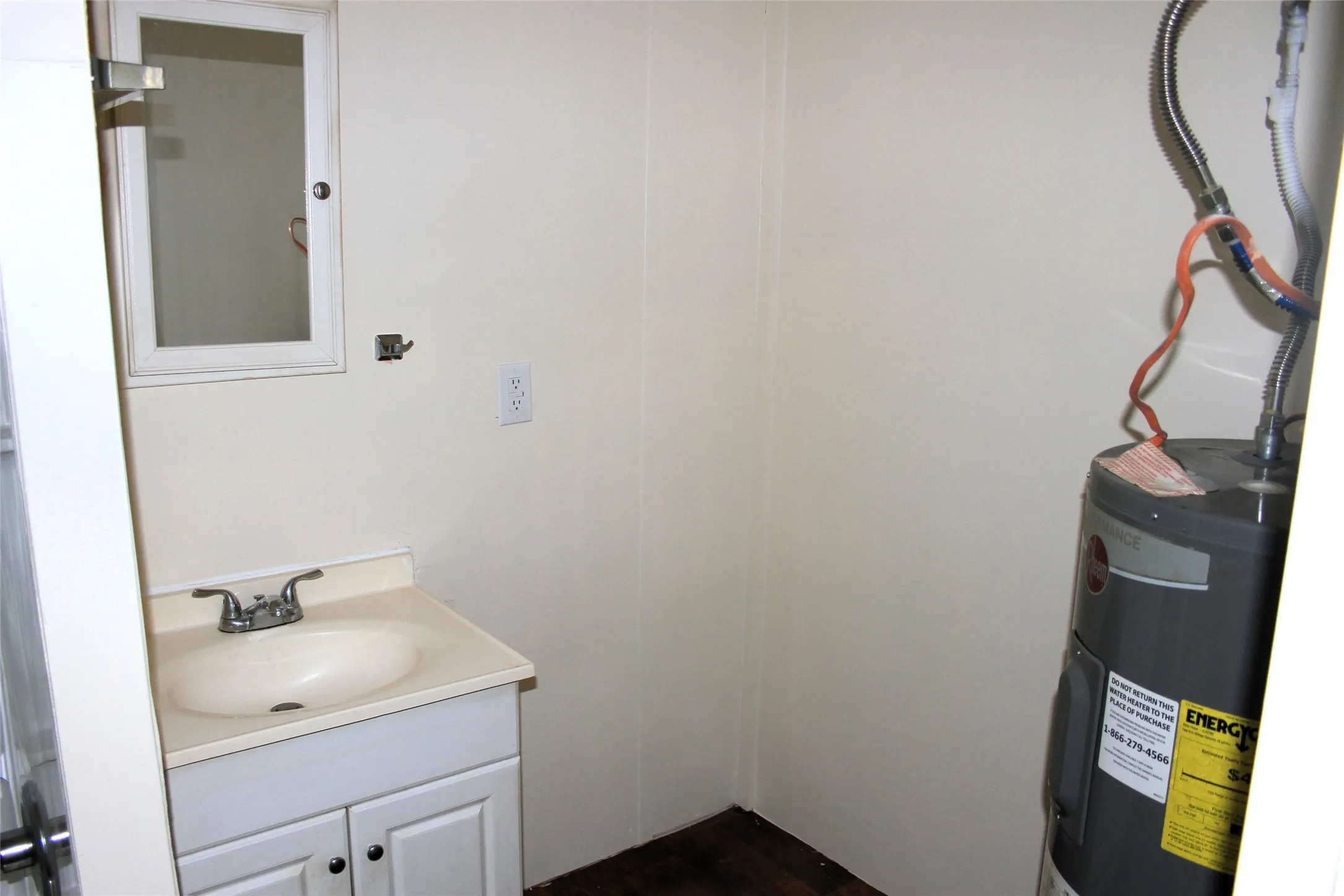 Bathroom featuring vanity and water heater