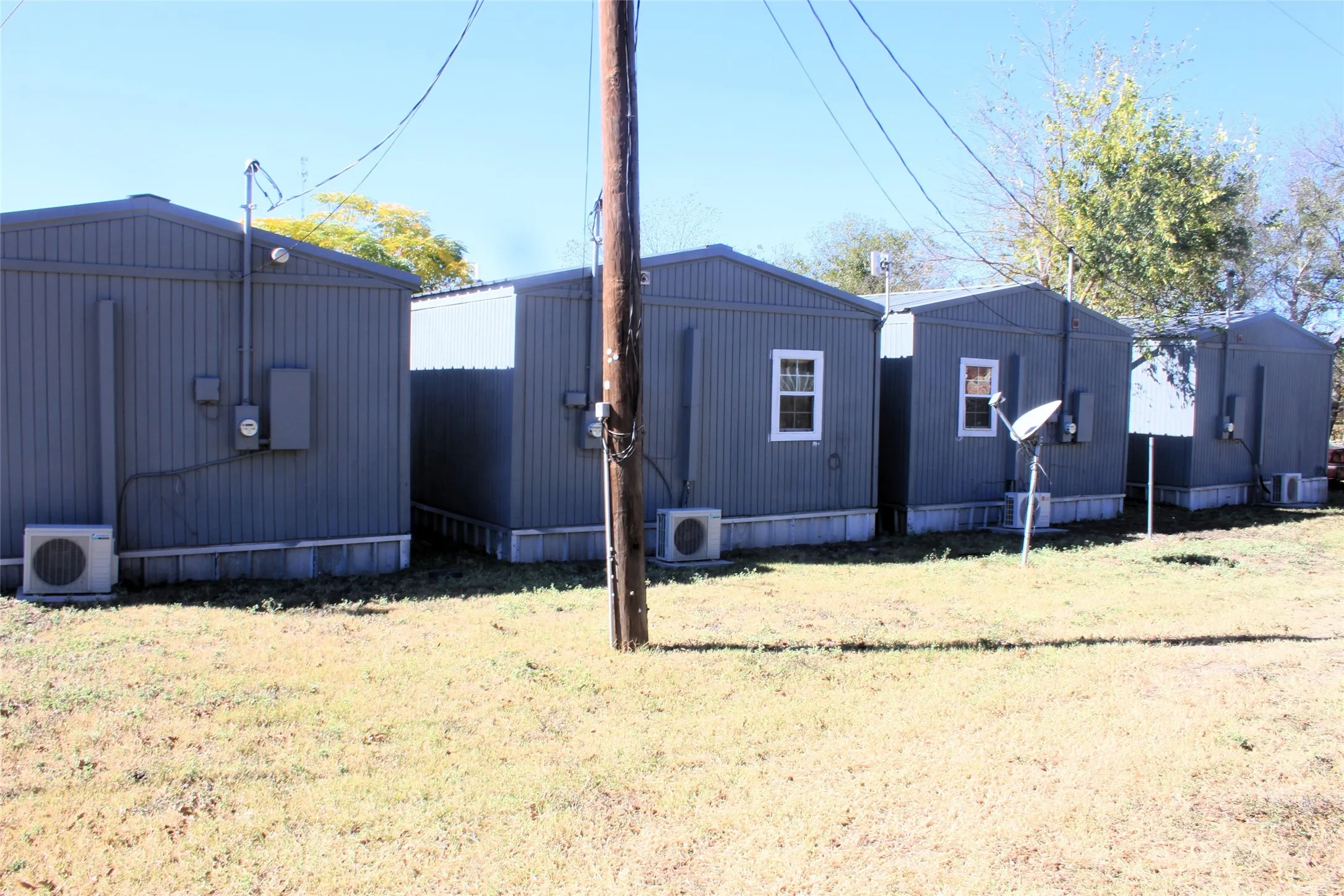 View of home's exterior featuring ac unit, a yard, and central AC unit