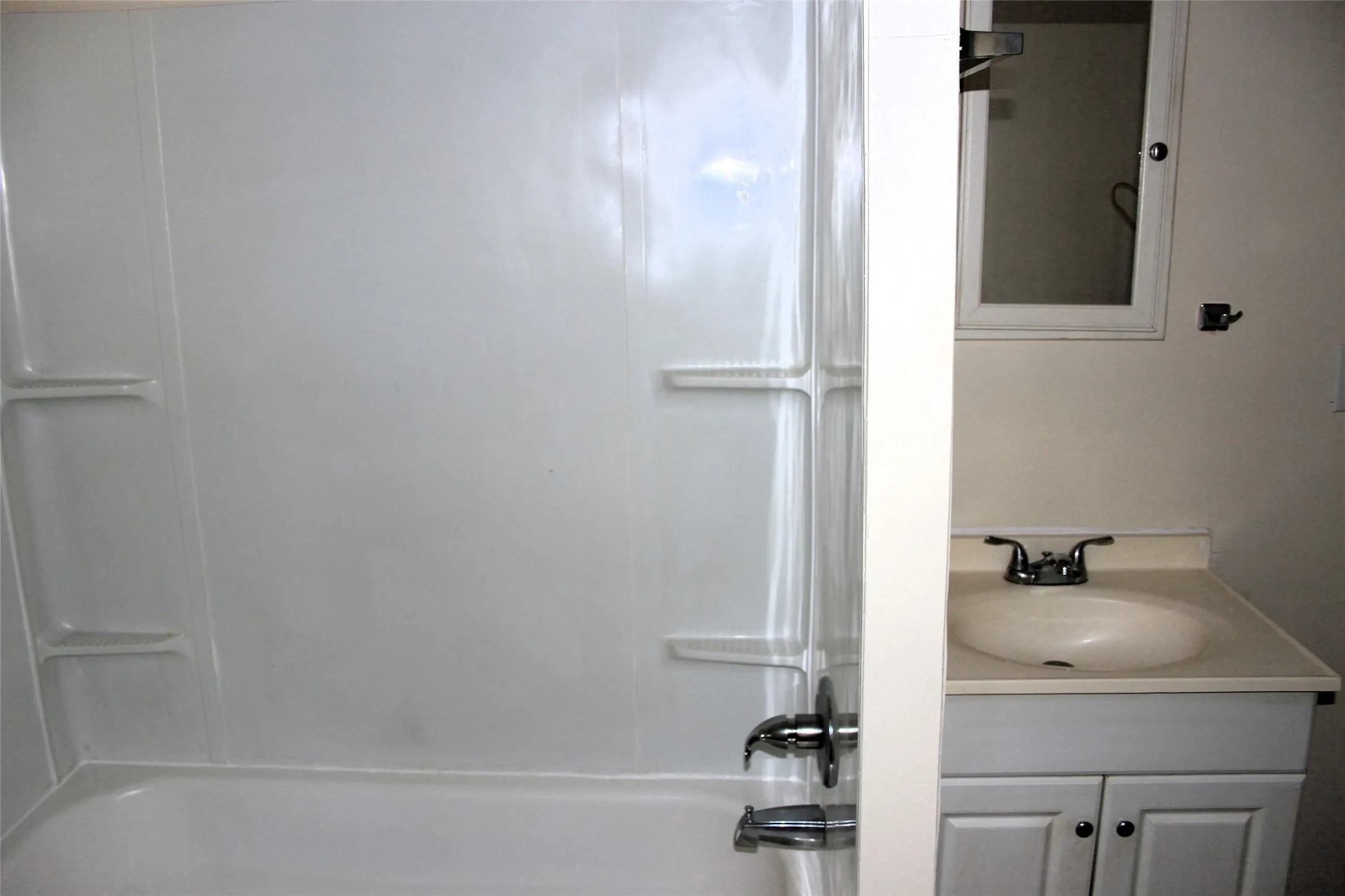 Bathroom with vanity and shower / bath combination