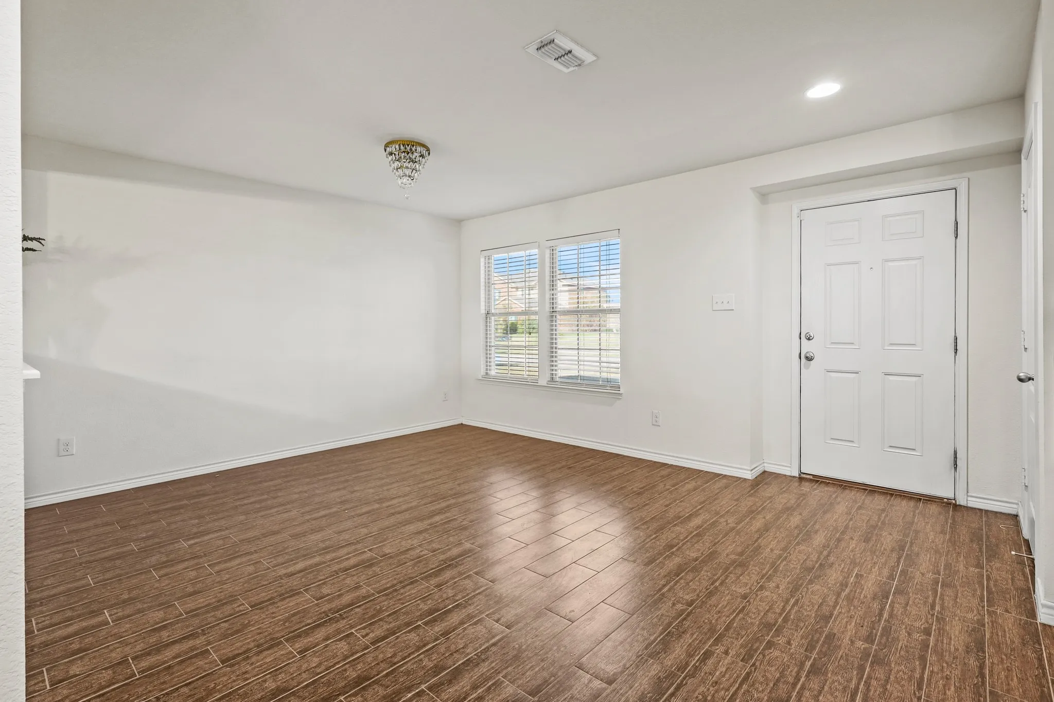 Empty room featuring dark hardwood / wood-style floors