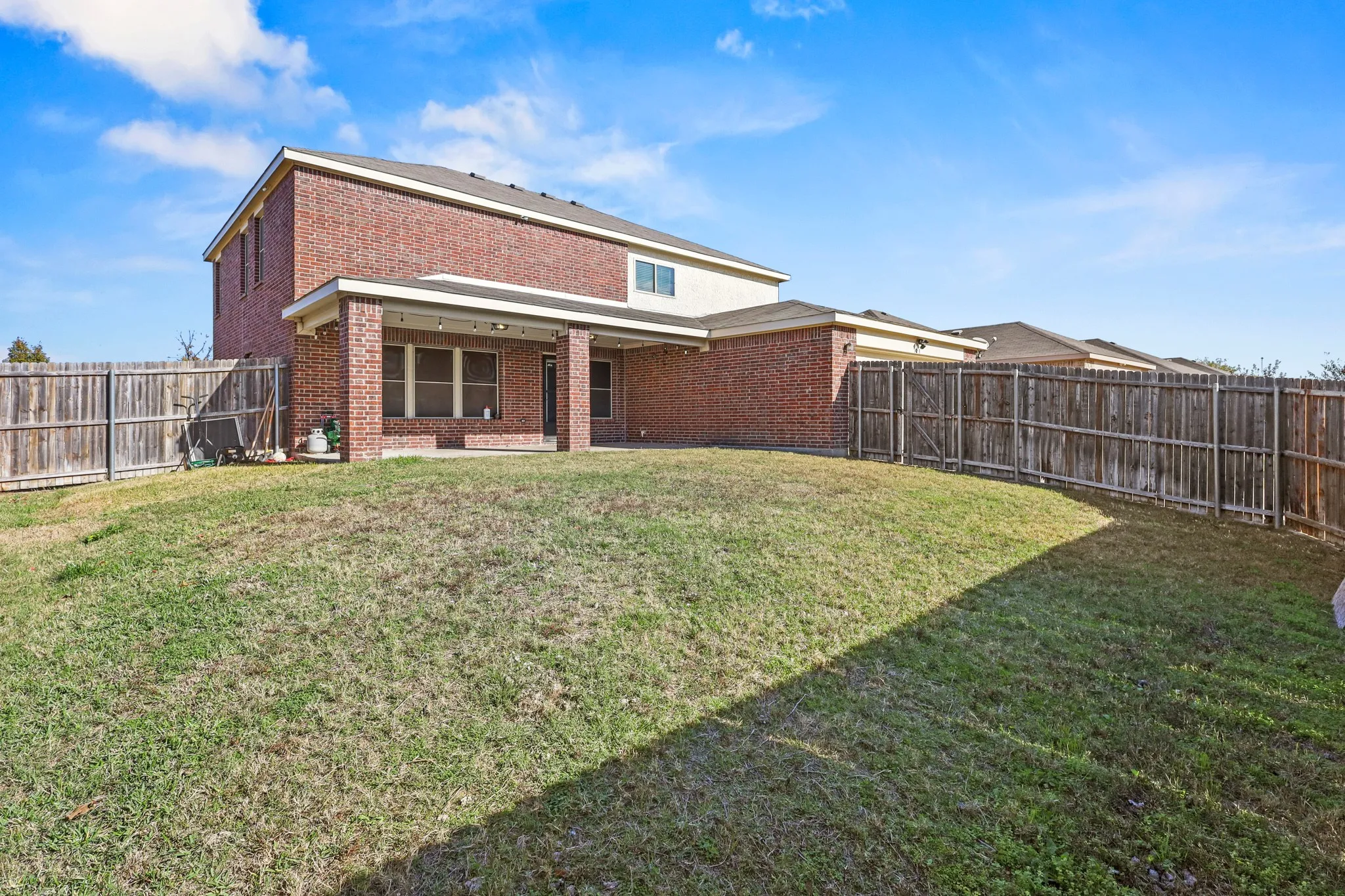 Rear view of house with a lawn