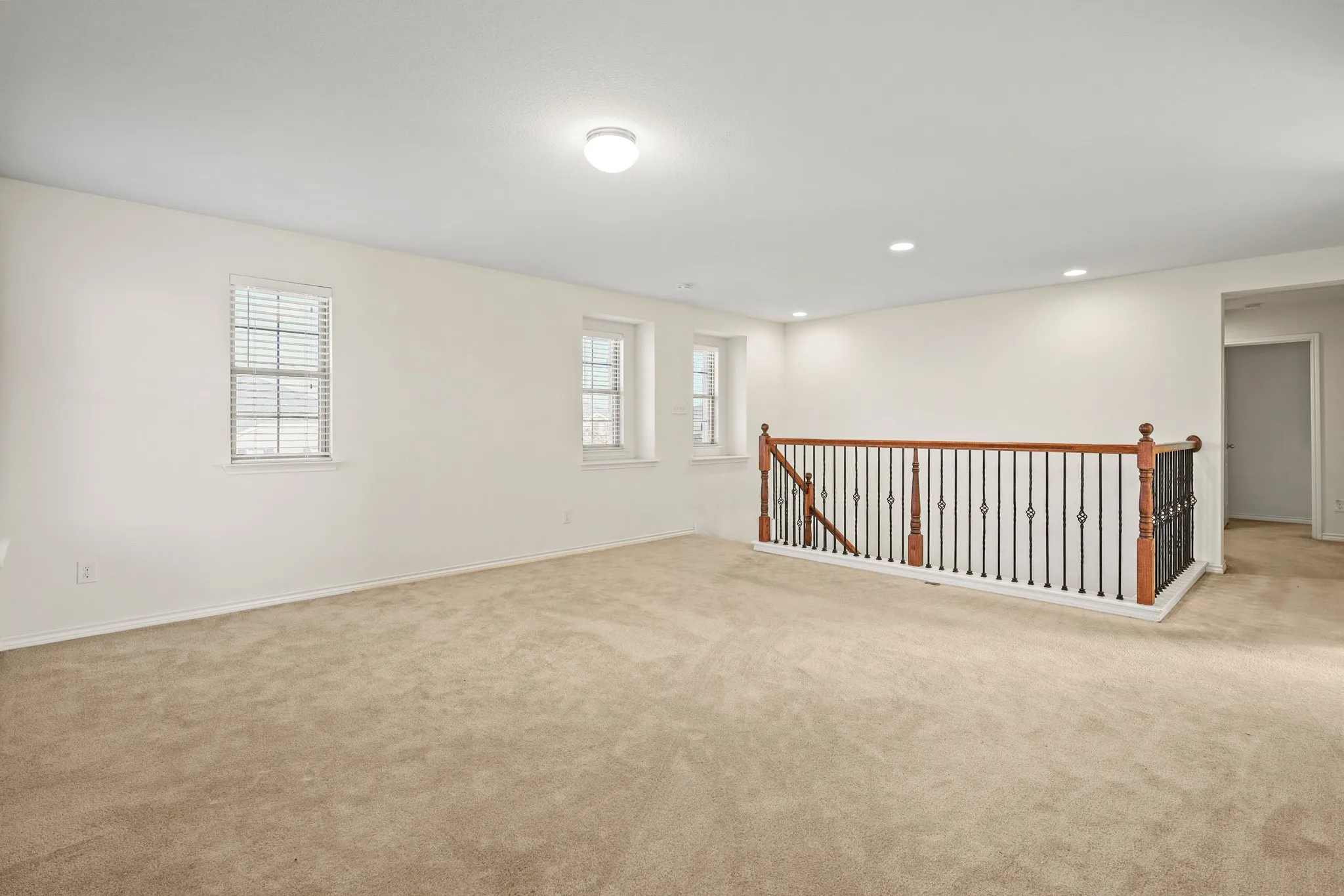 Unfurnished room with plenty of natural light and light carpet