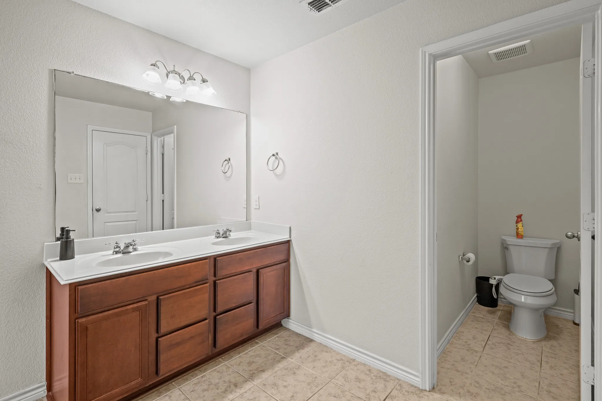 Bathroom with tile patterned floors, vanity, and toilet