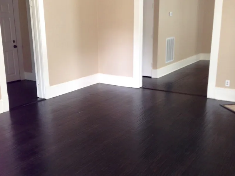 Empty room with dark hardwood / wood-style floors