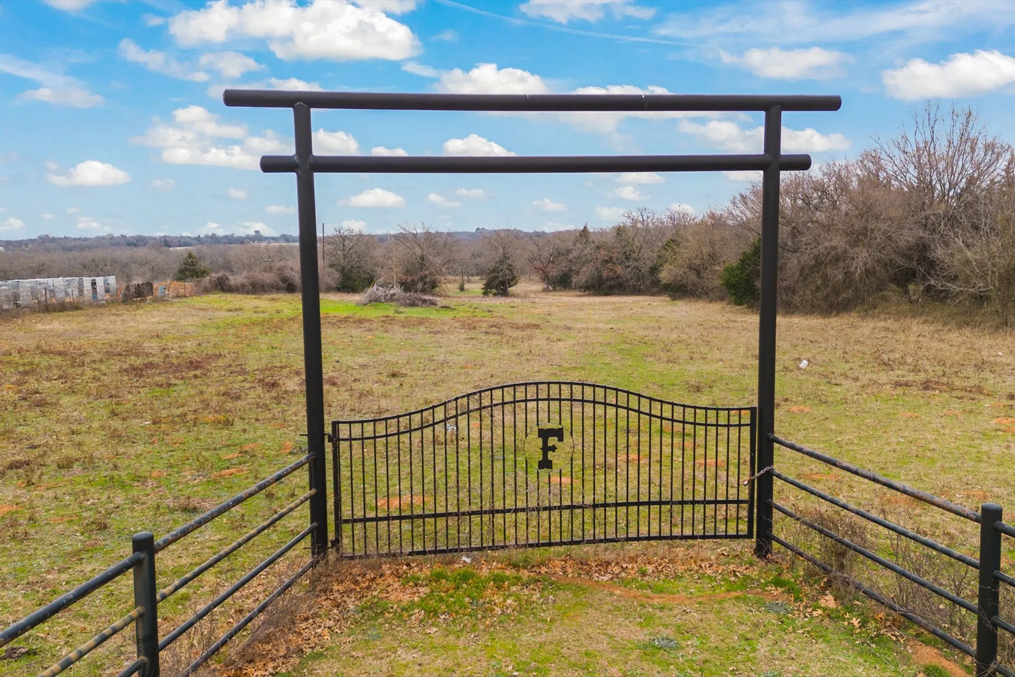 View of gate featuring a yard and a rural view