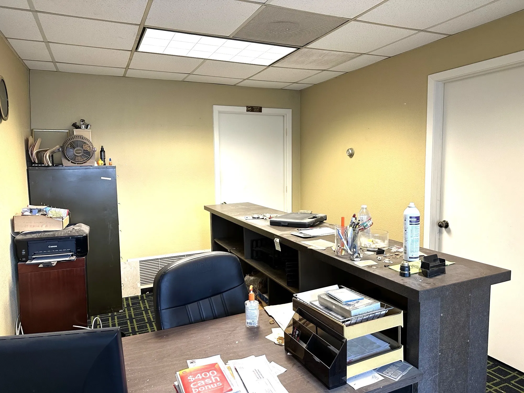 Office with wood finished floors and a paneled ceiling
