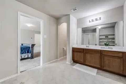 Bathroom with vanity and a shower with door