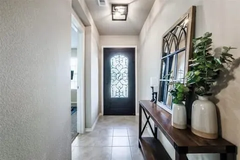 Doorway to outside featuring light tile patterned floors
