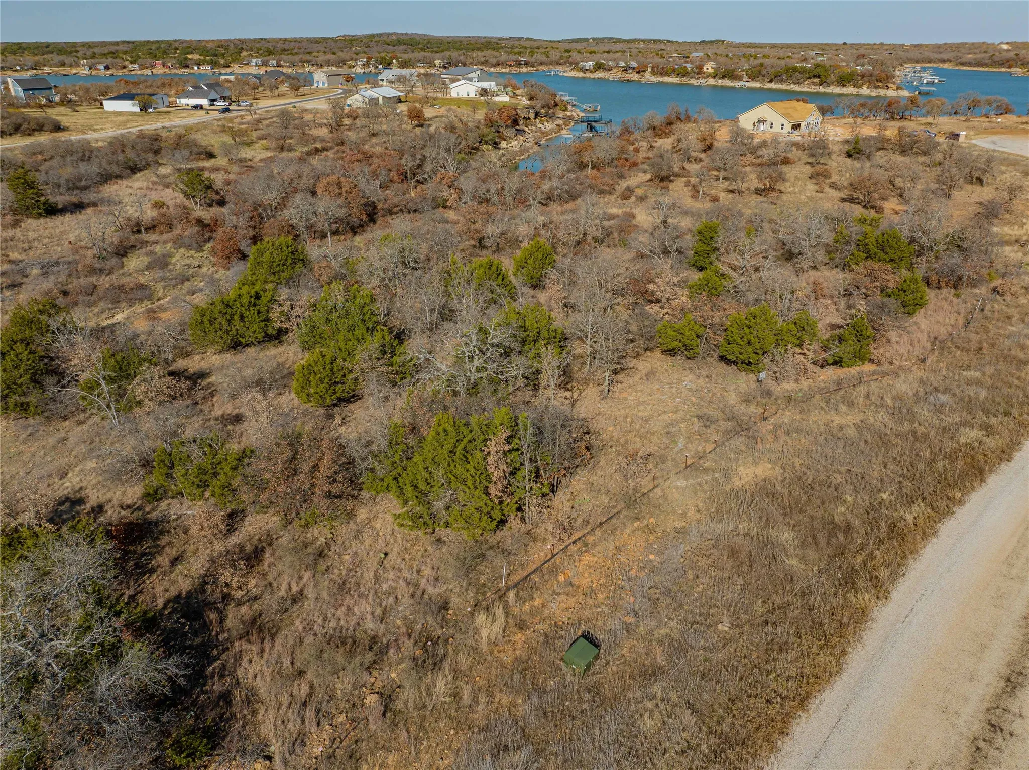 Birds eye view of property with a water view