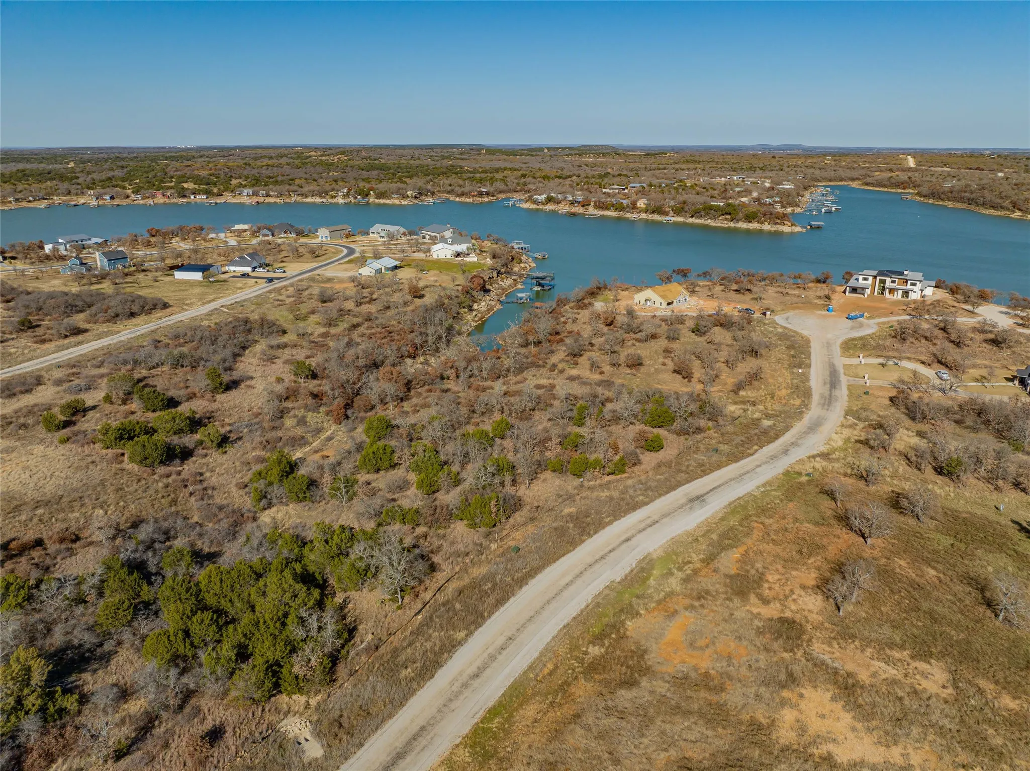 Birds eye view of property with a water view