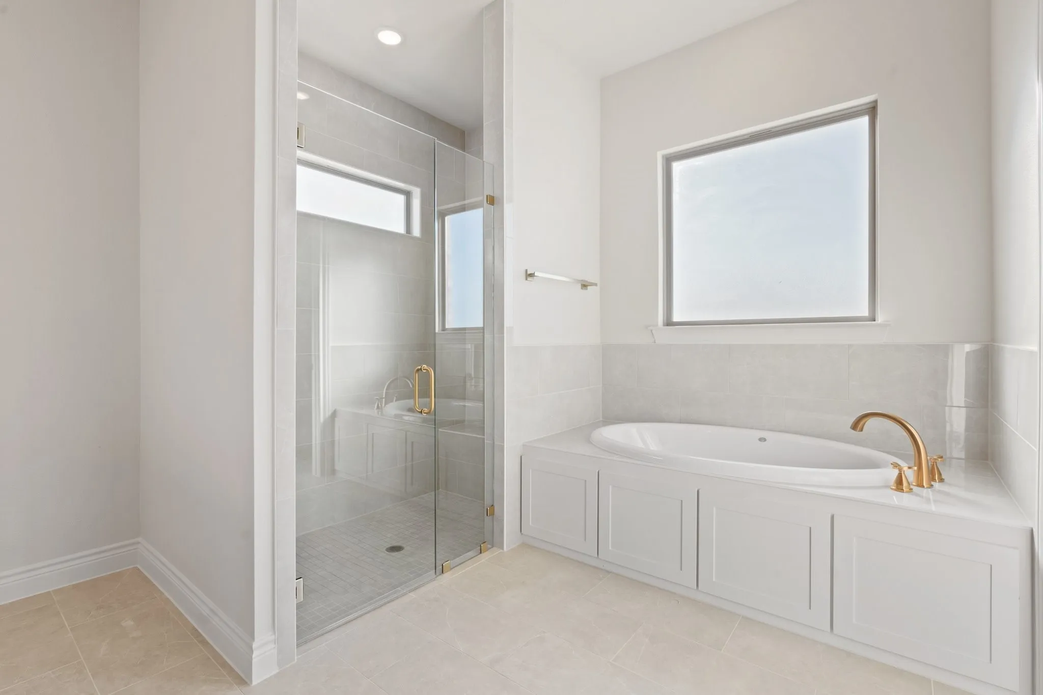 Large walk in shower with a bench and deep garden tub