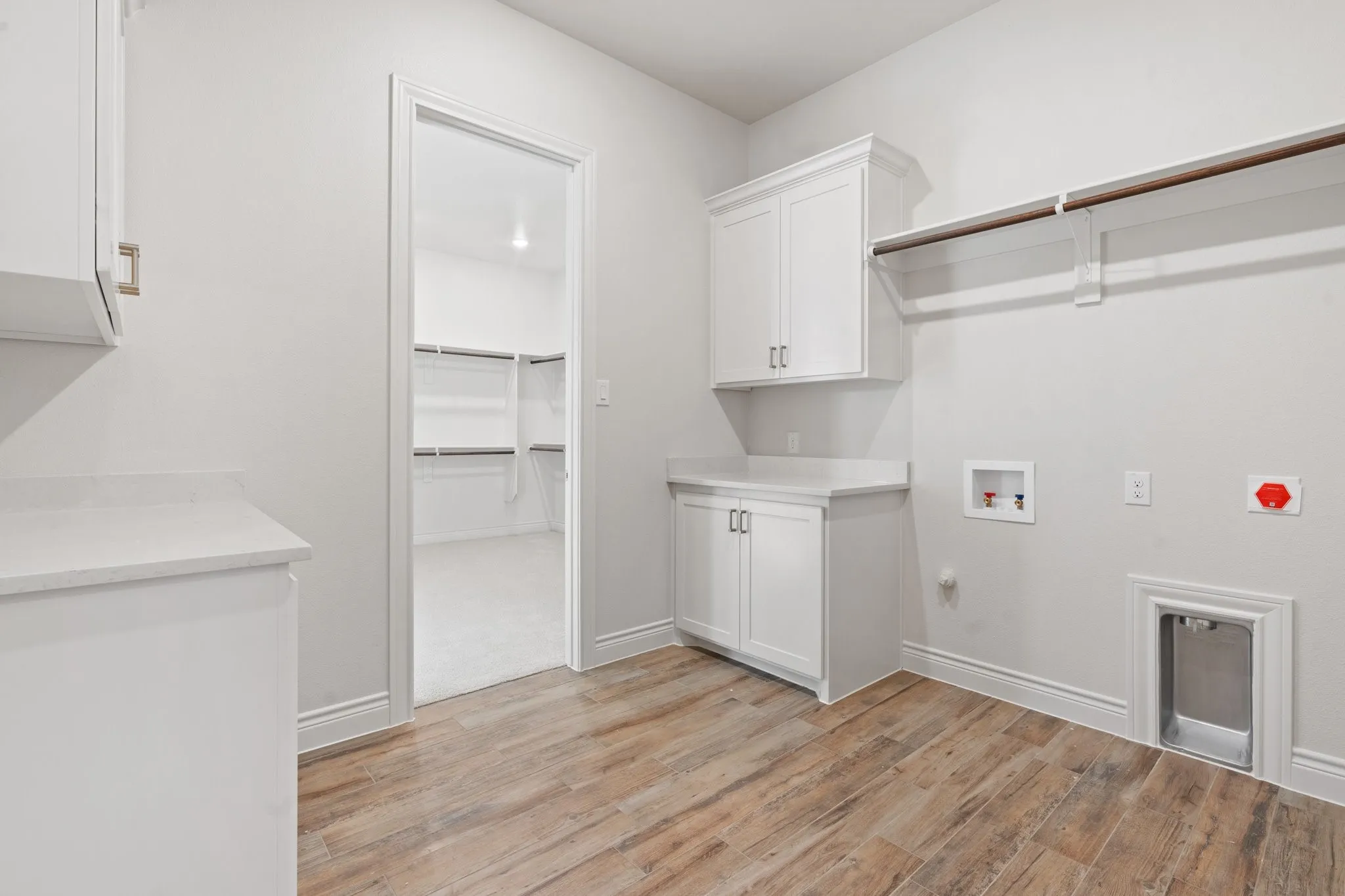 Utility Room with cabinets, countertops, hanging bar to hang clothes AND it connects to the Main Closet