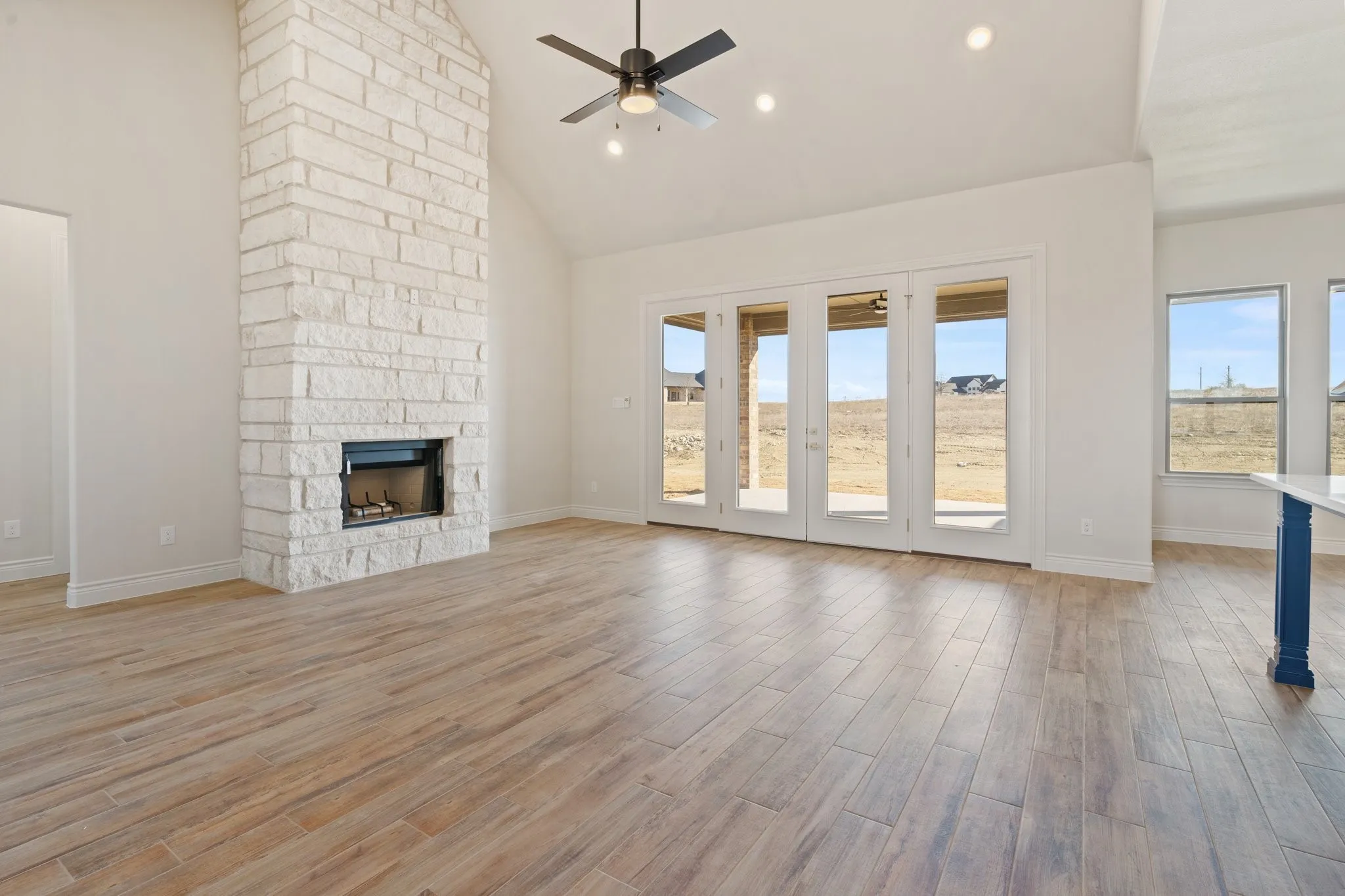 Beautiful stone to ceiling fireplace with a wood beam across the top.