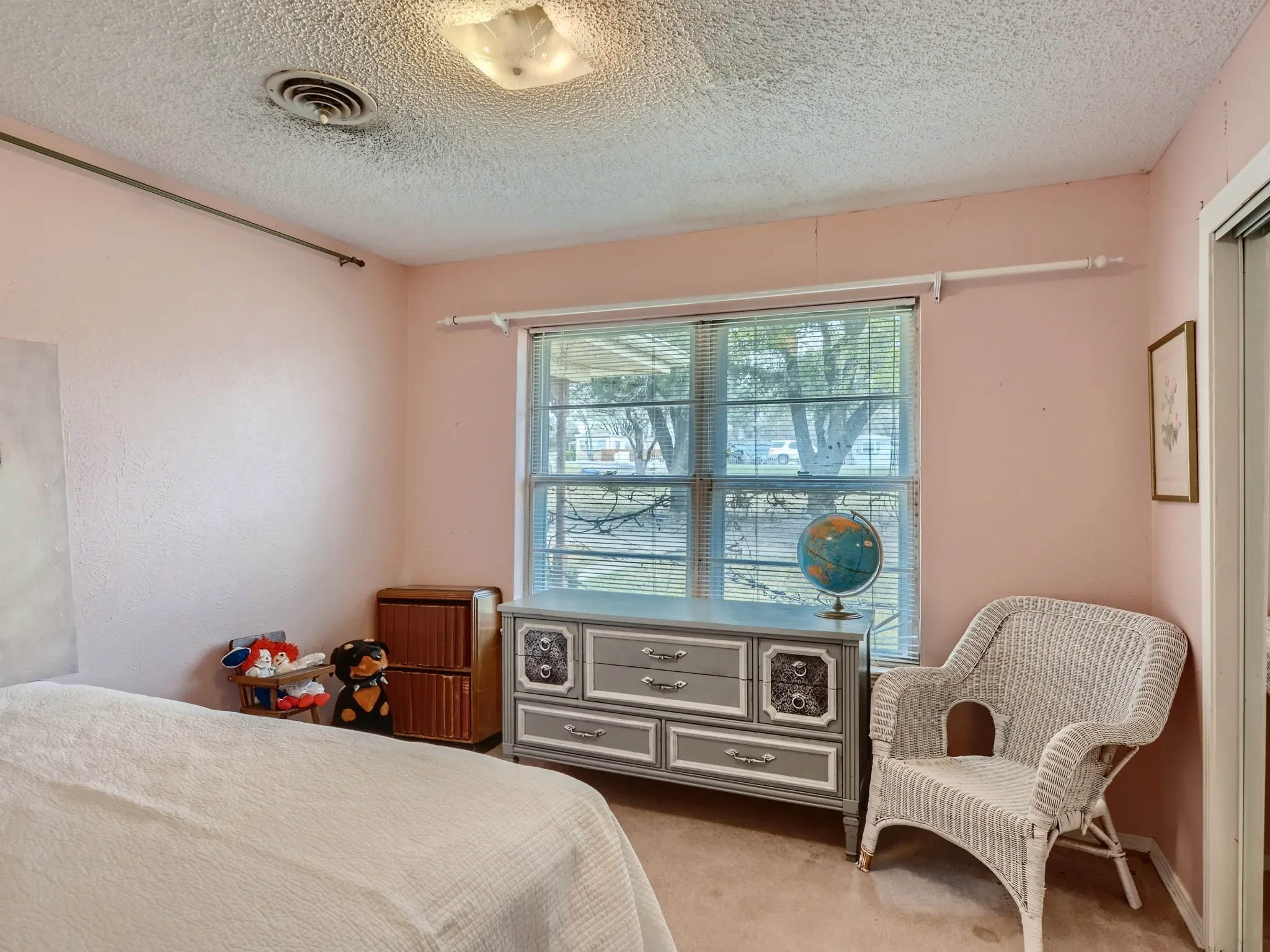 Carpeted bedroom featuring a textured ceiling