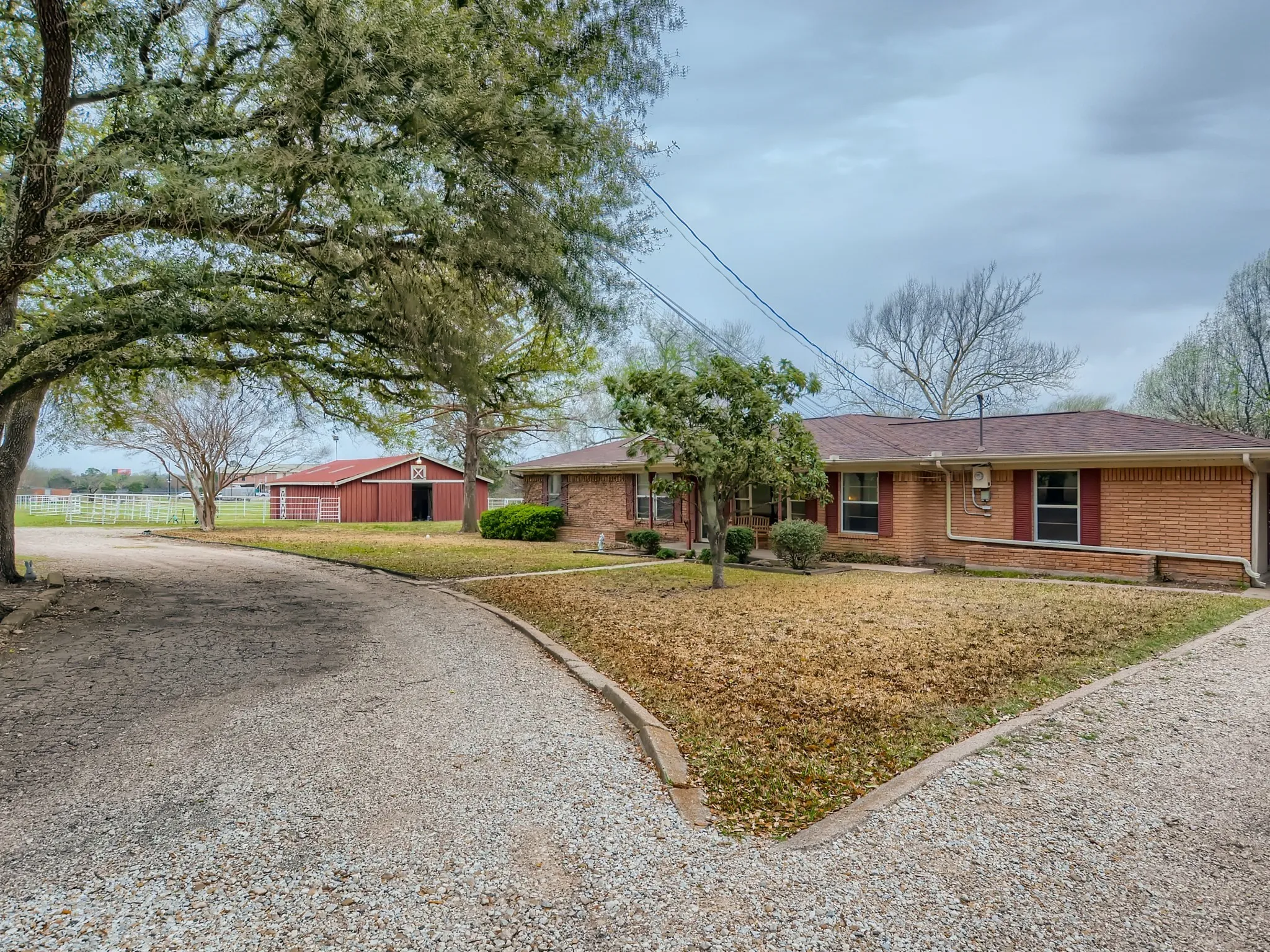 Ranch-style home with an outdoor structure and a front lawn