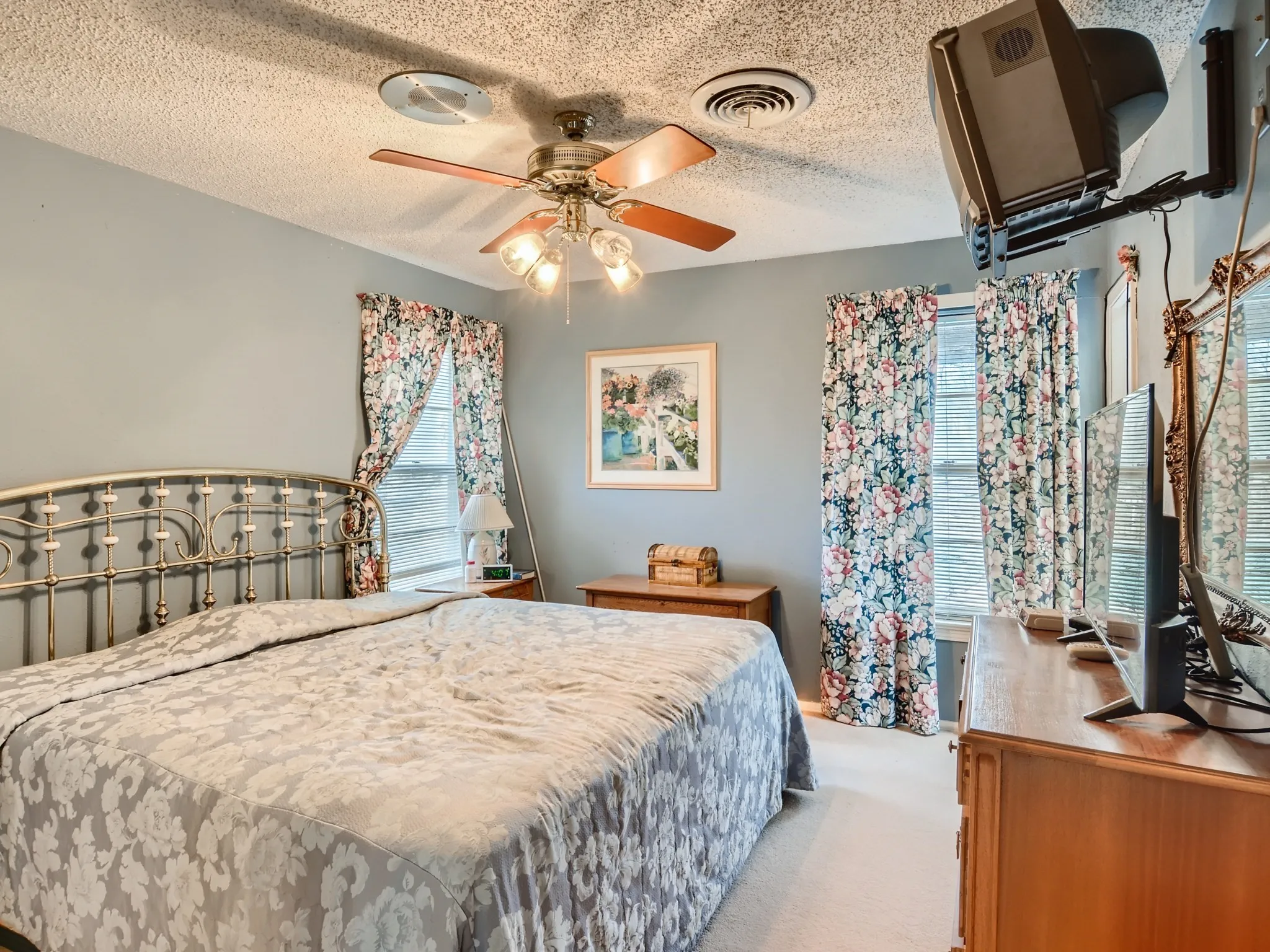 Bedroom with carpet flooring, a textured ceiling, and ceiling fan