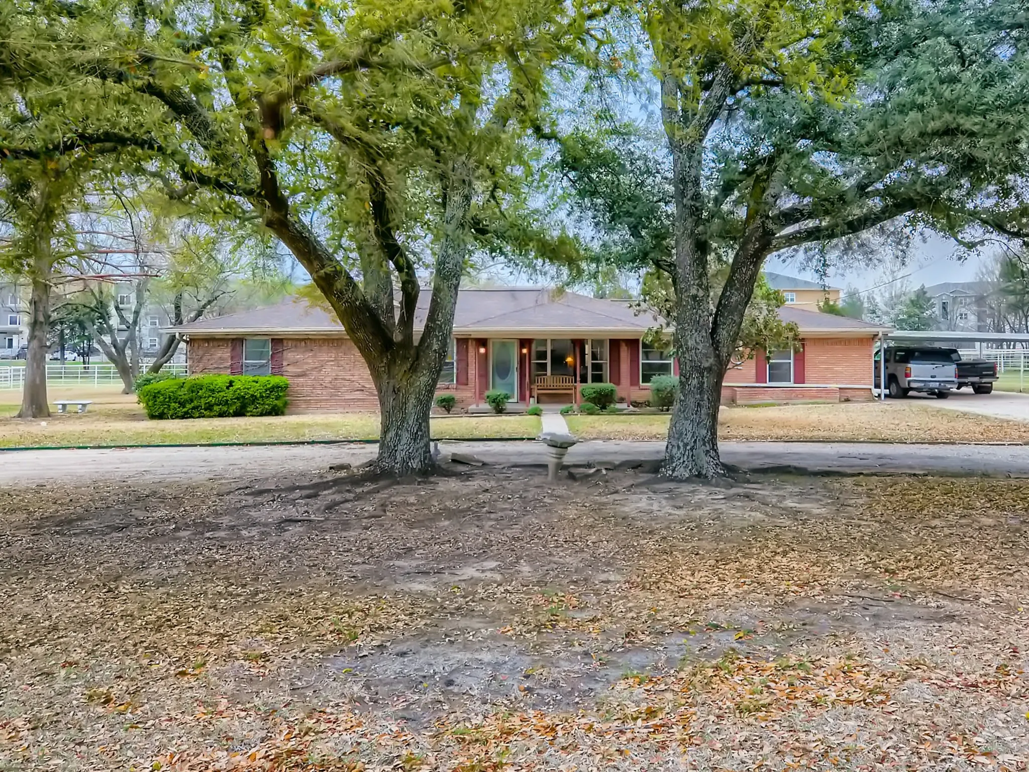 Ranch-style home with covered porch and a carport
