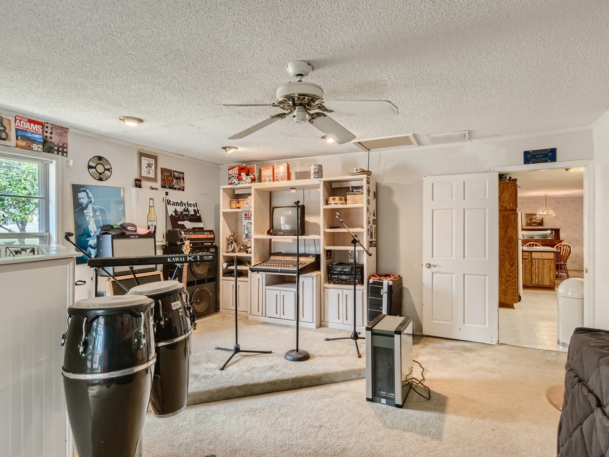 Home office with carpet, a textured ceiling, and ceiling fan