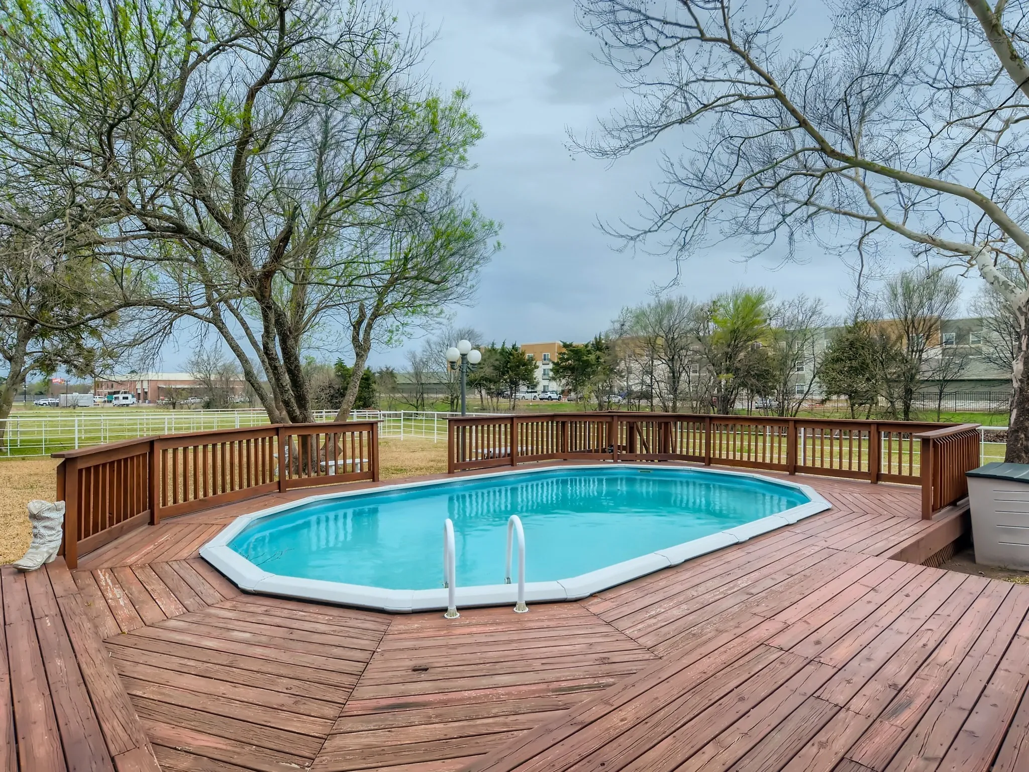 View of pool featuring a wooden deck