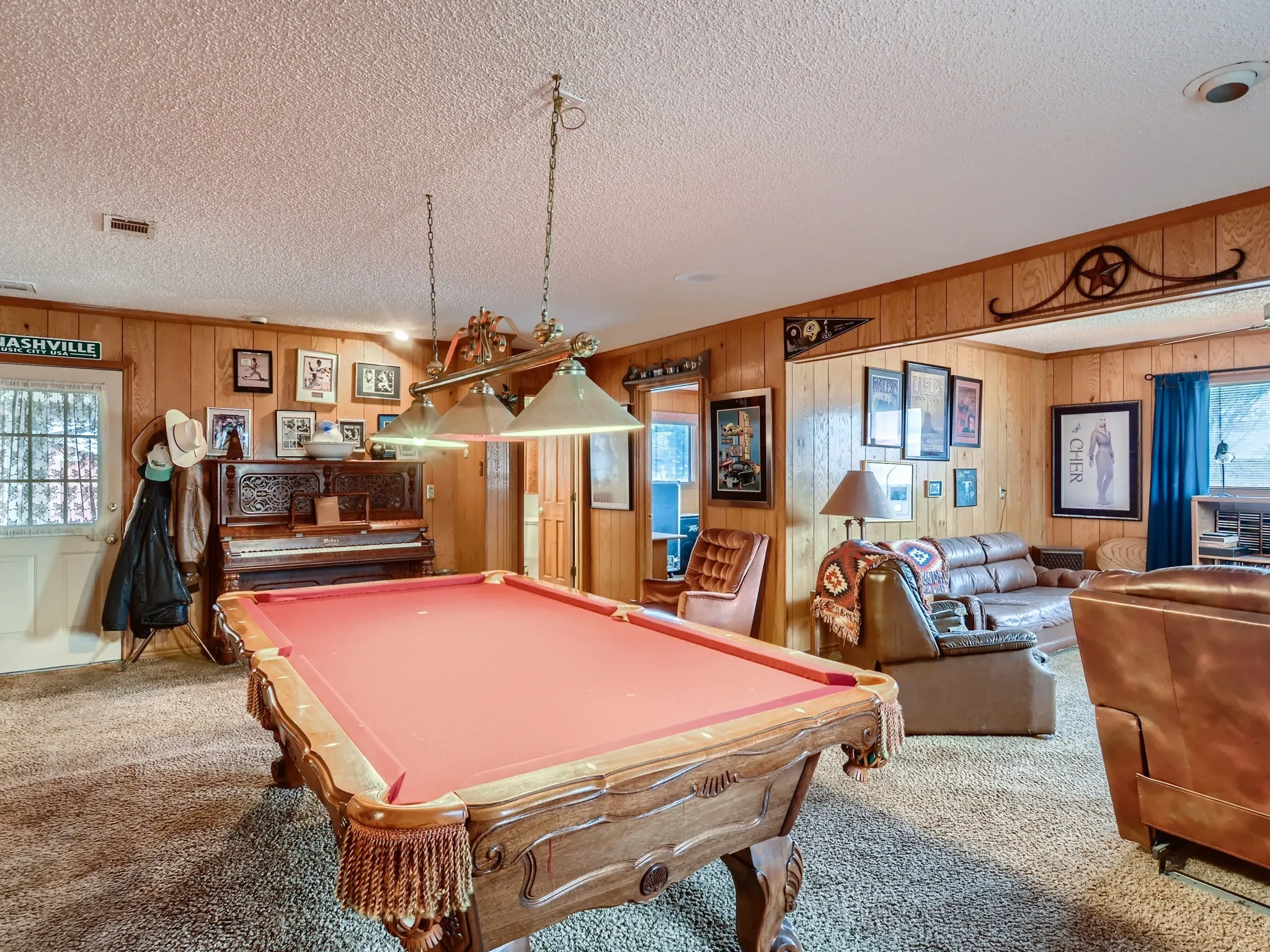 Recreation room with carpet, wood walls, a textured ceiling, and billiards