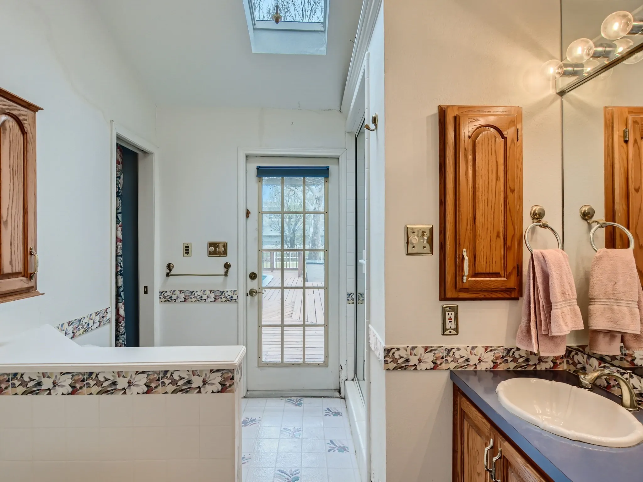 Bathroom featuring vanity and a skylight