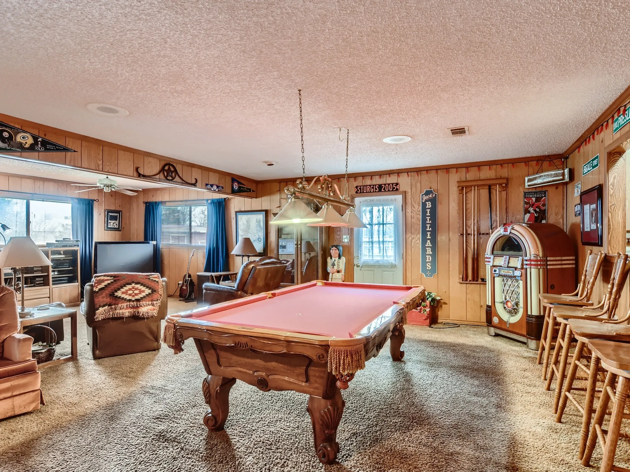 Rec room with carpet floors, billiards, a healthy amount of sunlight, and wood walls