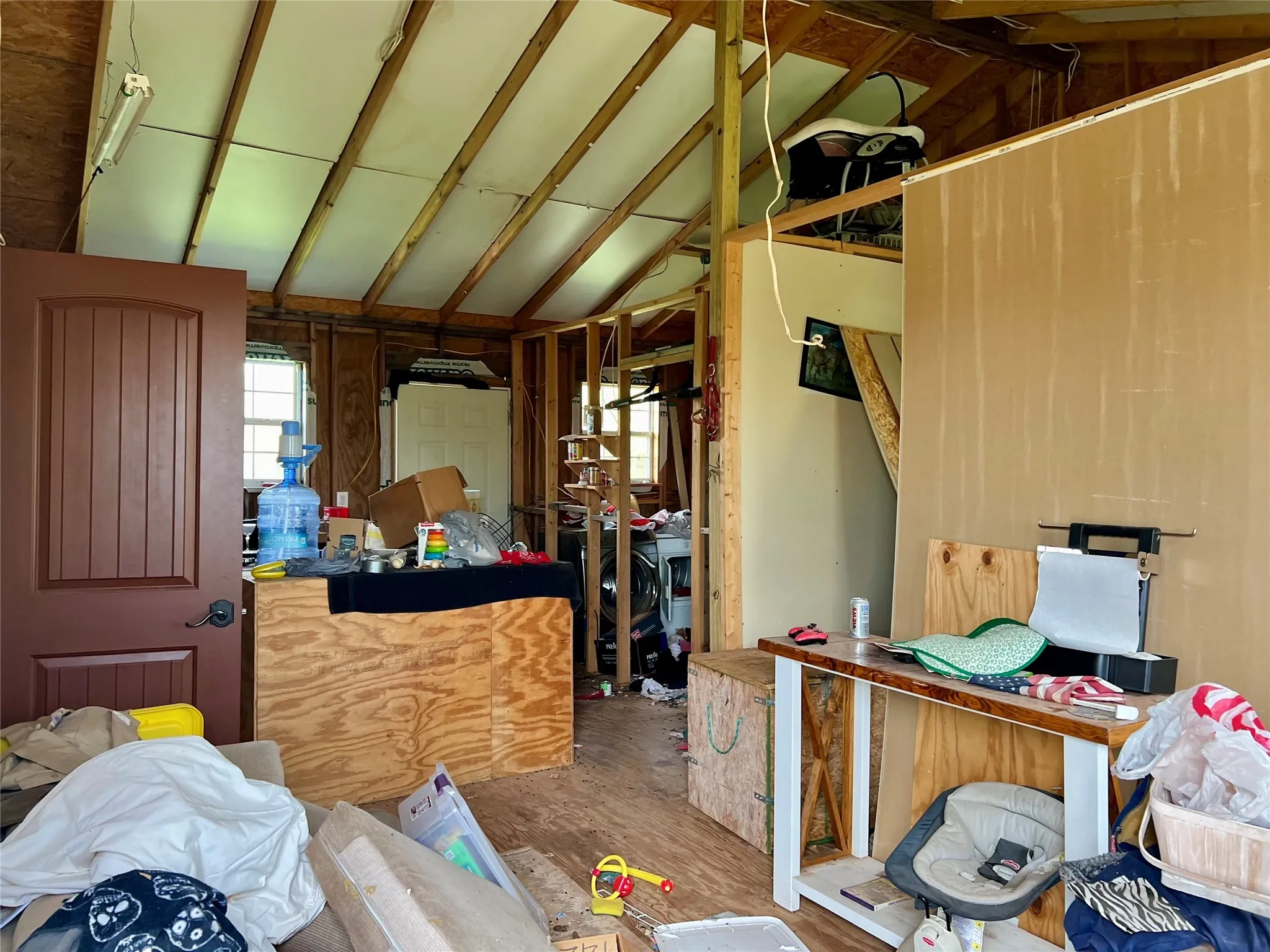 Kitchen featuring vaulted ceiling with beams and hardwood / wood-style flooring