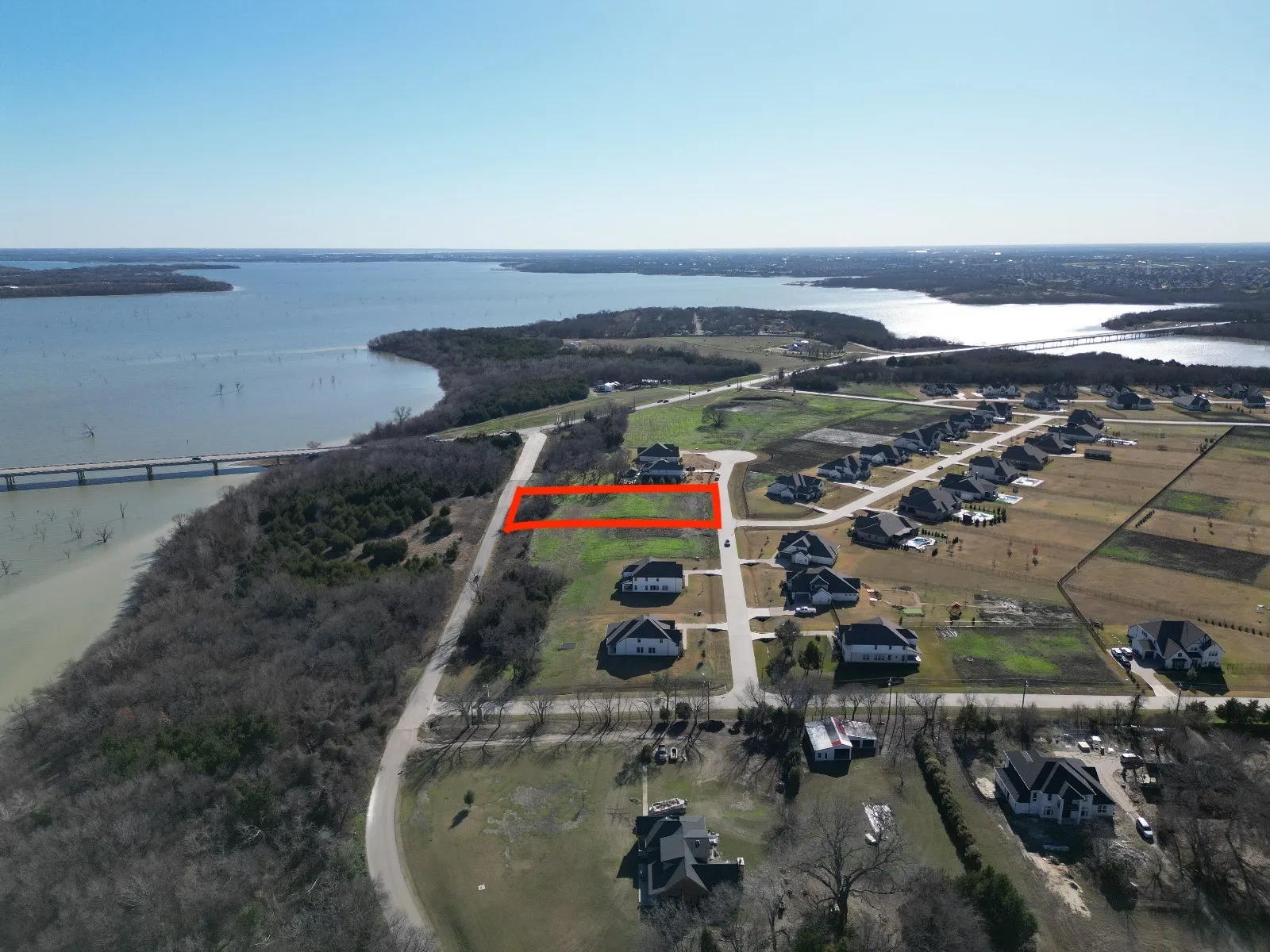 Birds eye view of property with a water view