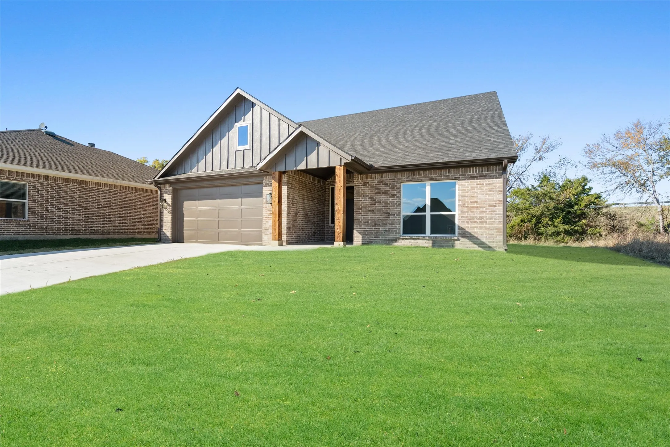 View of front facade with a front yard and a garage
