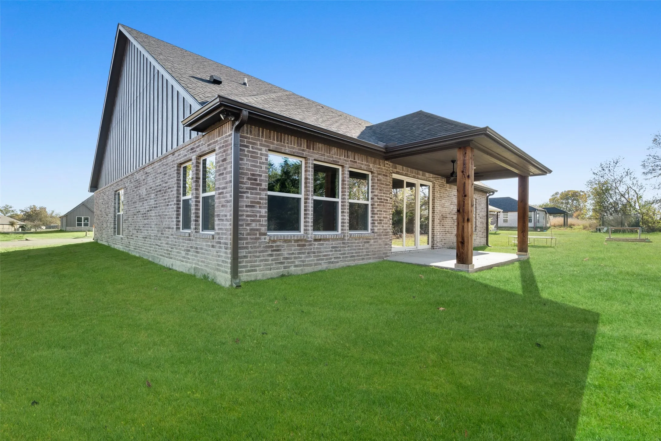 Back of property featuring a patio area and a yard