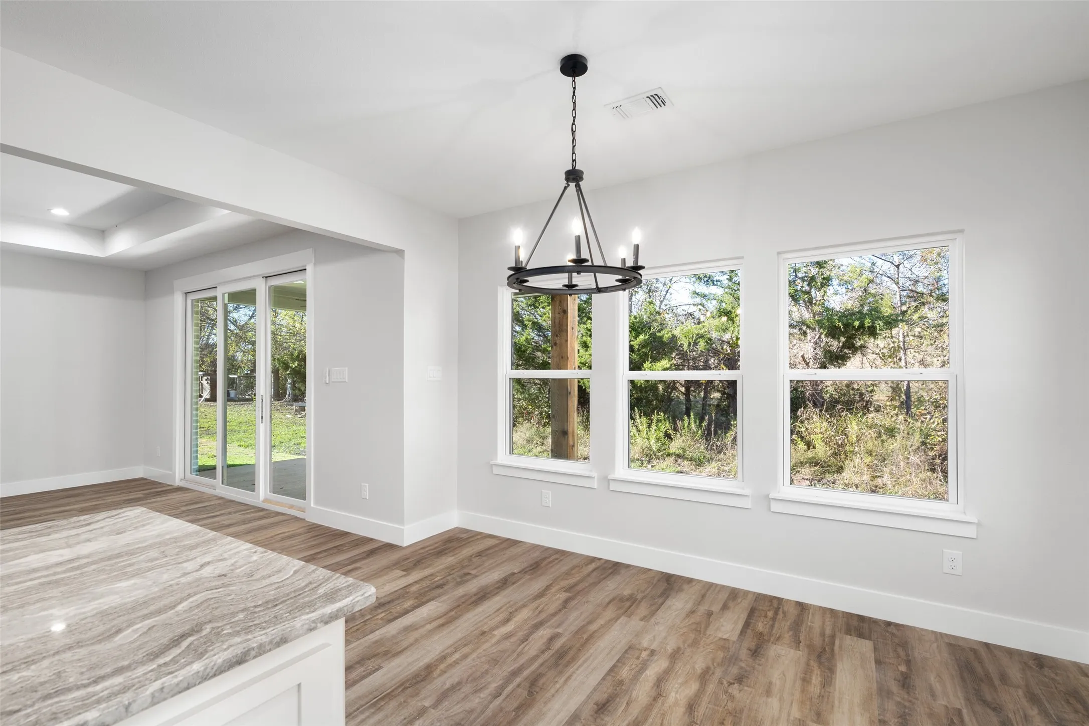Unfurnished dining area featuring hardwood / wood-style floors and a chandelier