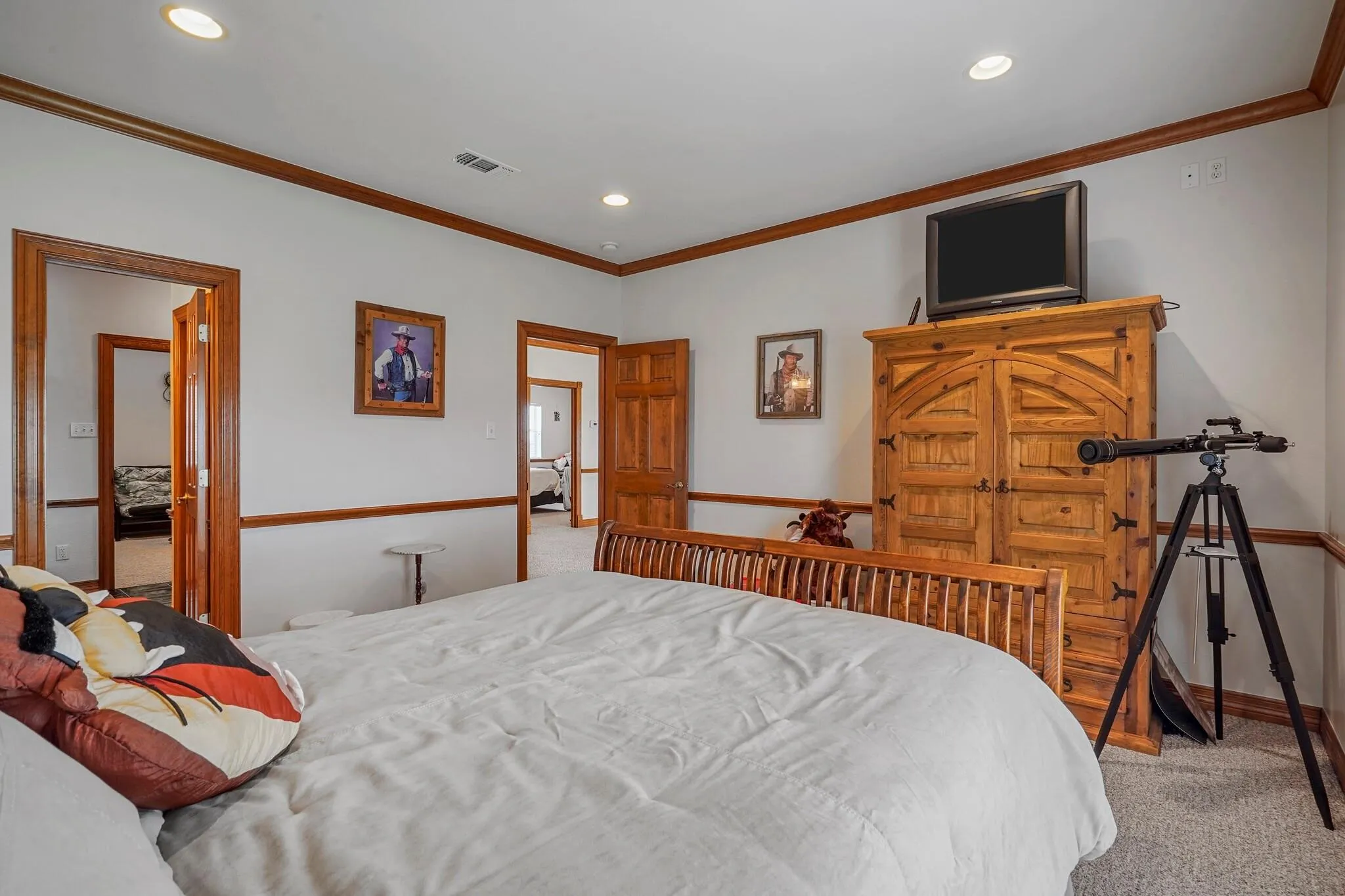 Carpeted bedroom with ornamental molding