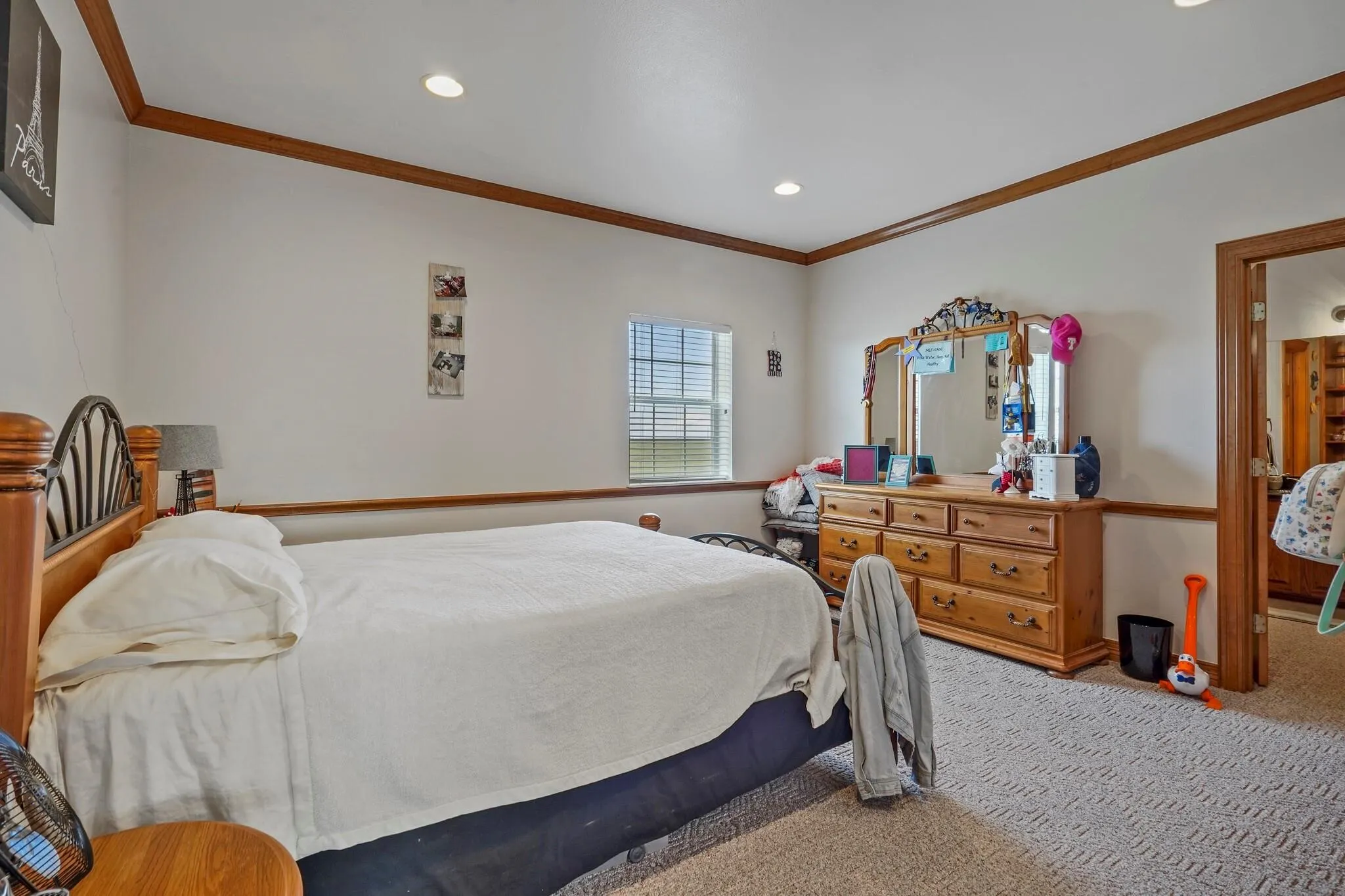 Carpeted bedroom featuring ornamental molding